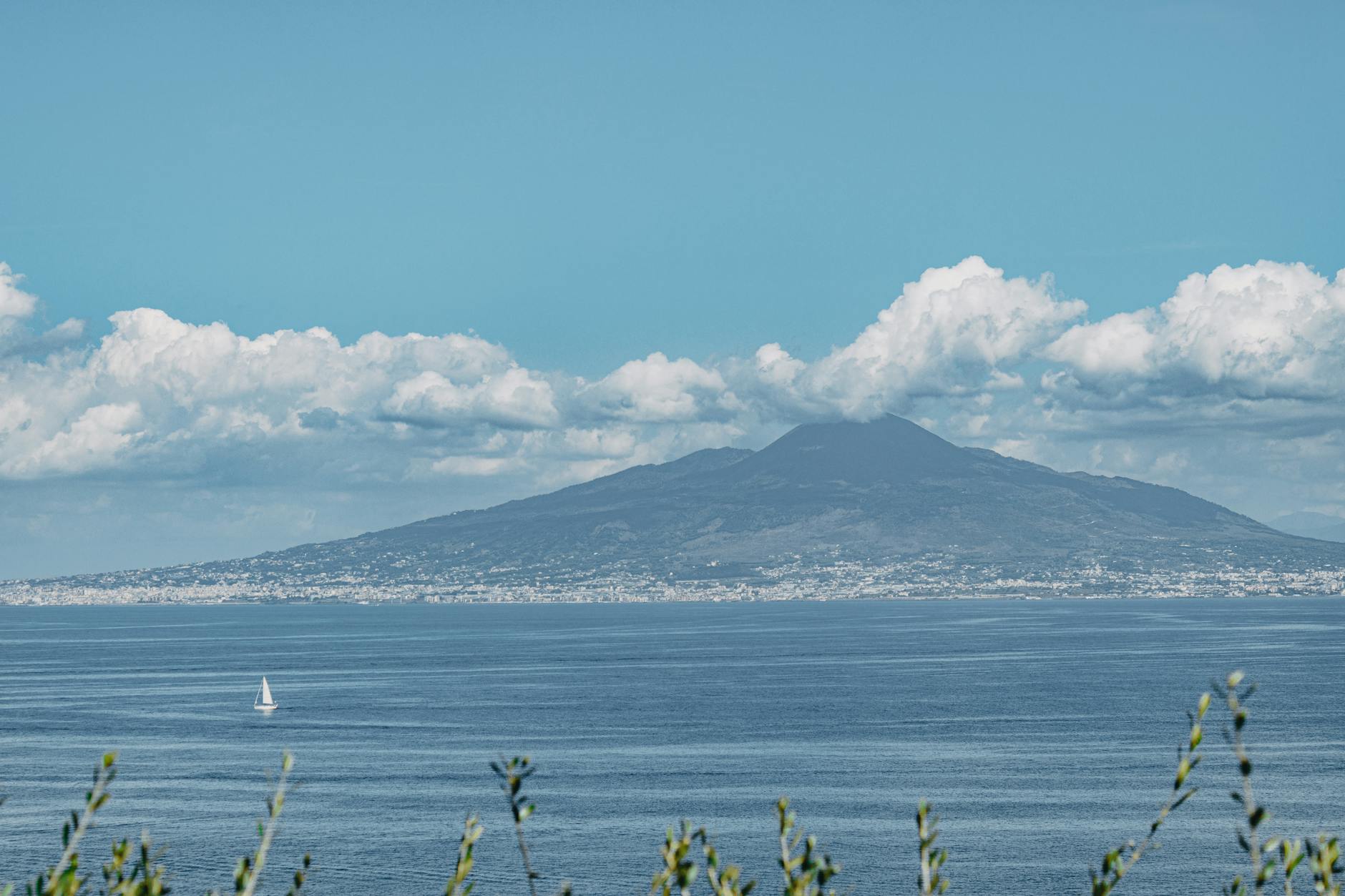 Sailboat on the Bay of Naples with Mount Vesuvius under a clear sky