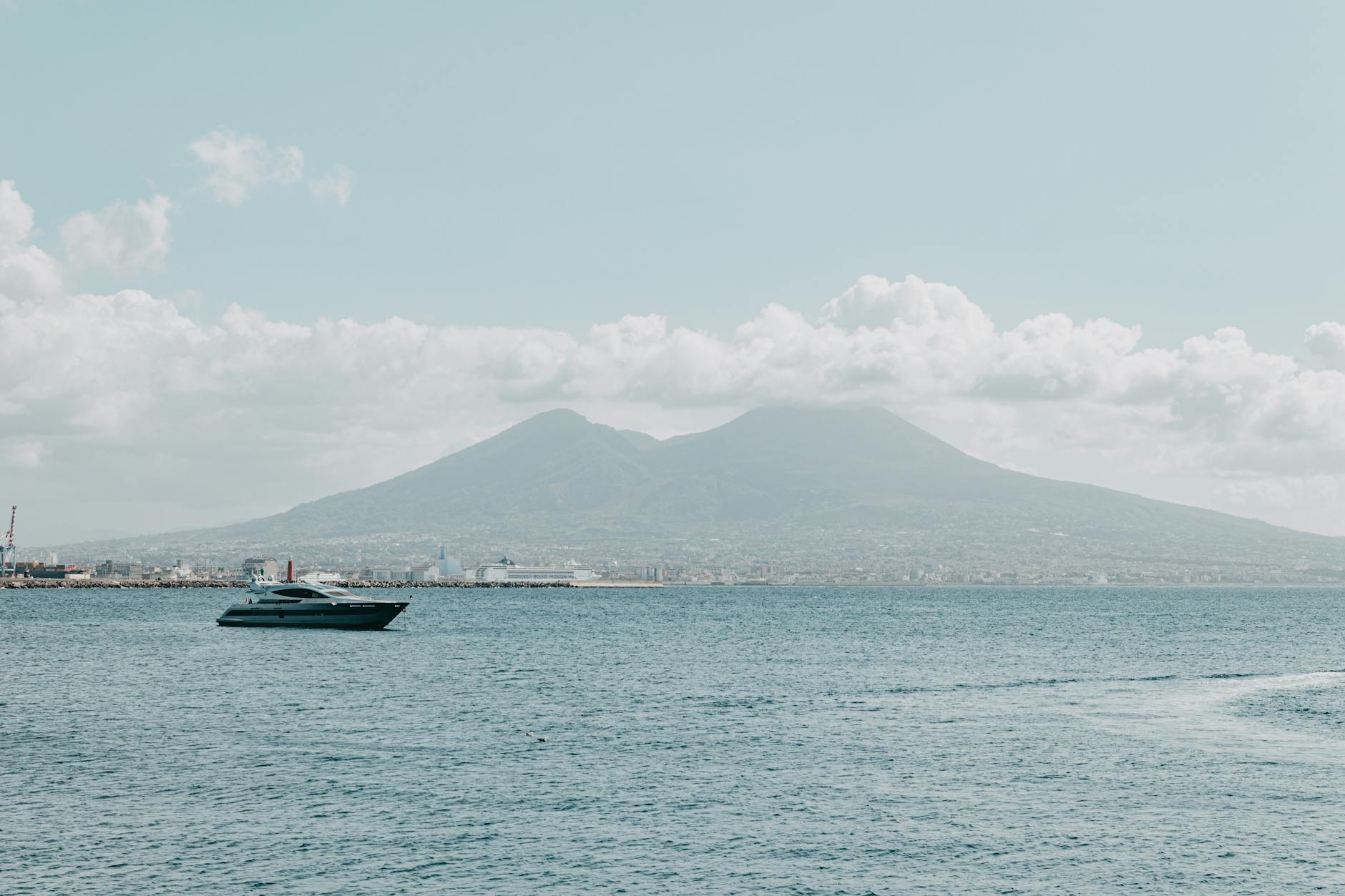 Yacht sailing with Mount Vesuvius behind the Bay of Naples
