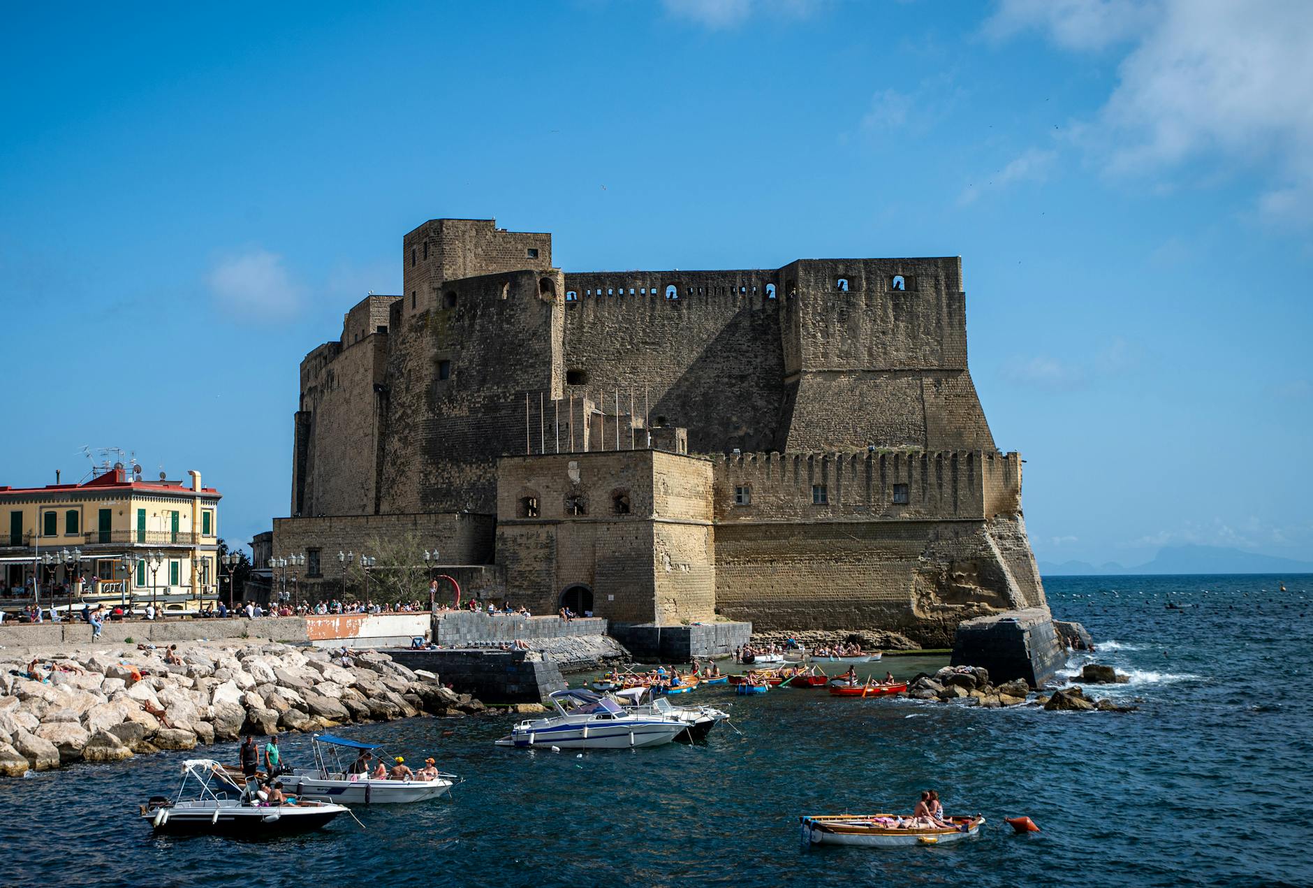 Castel dell'Ovo, boats, and Mediterranean Sea in Naples