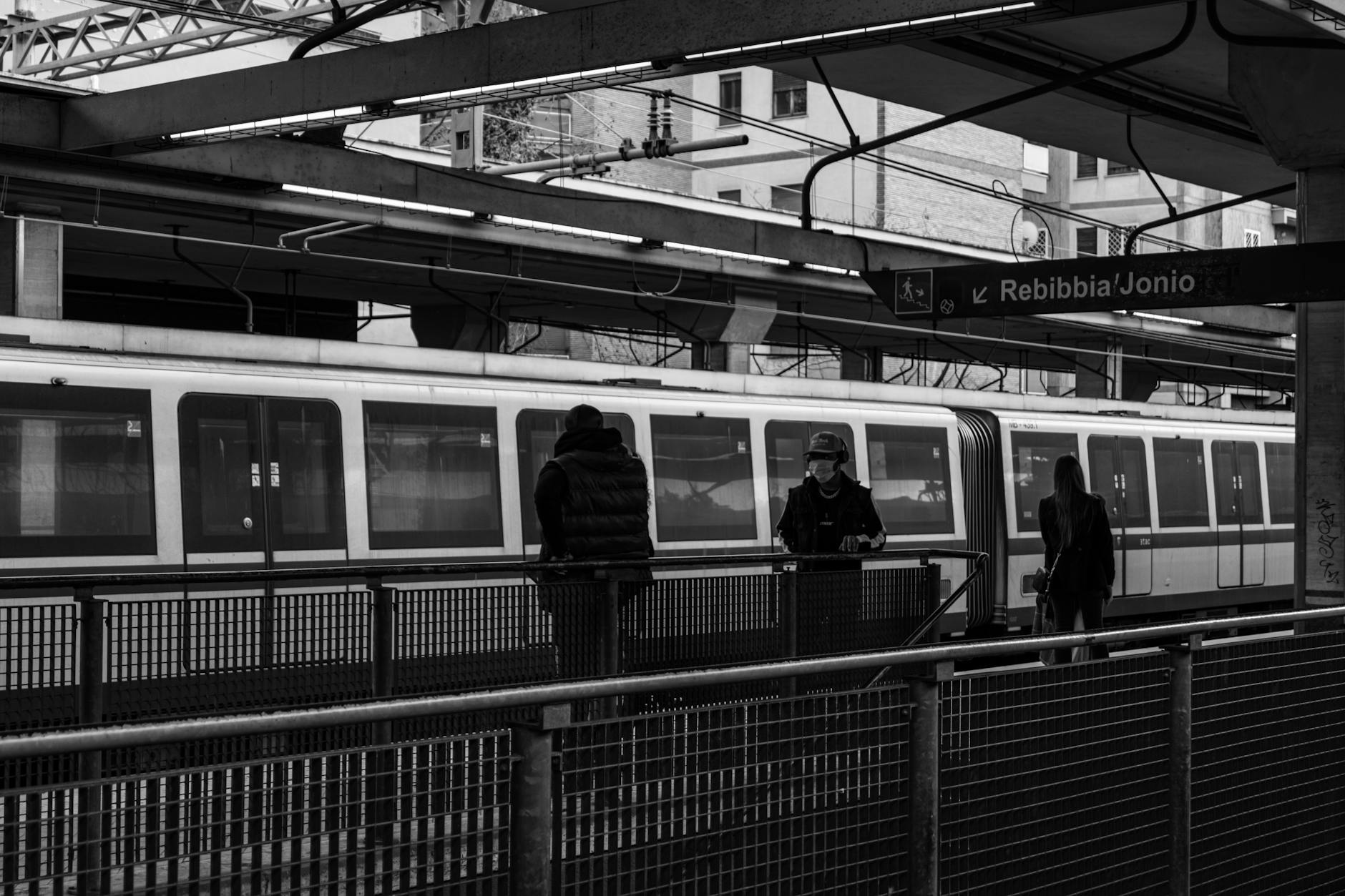People walking on a railway station platform