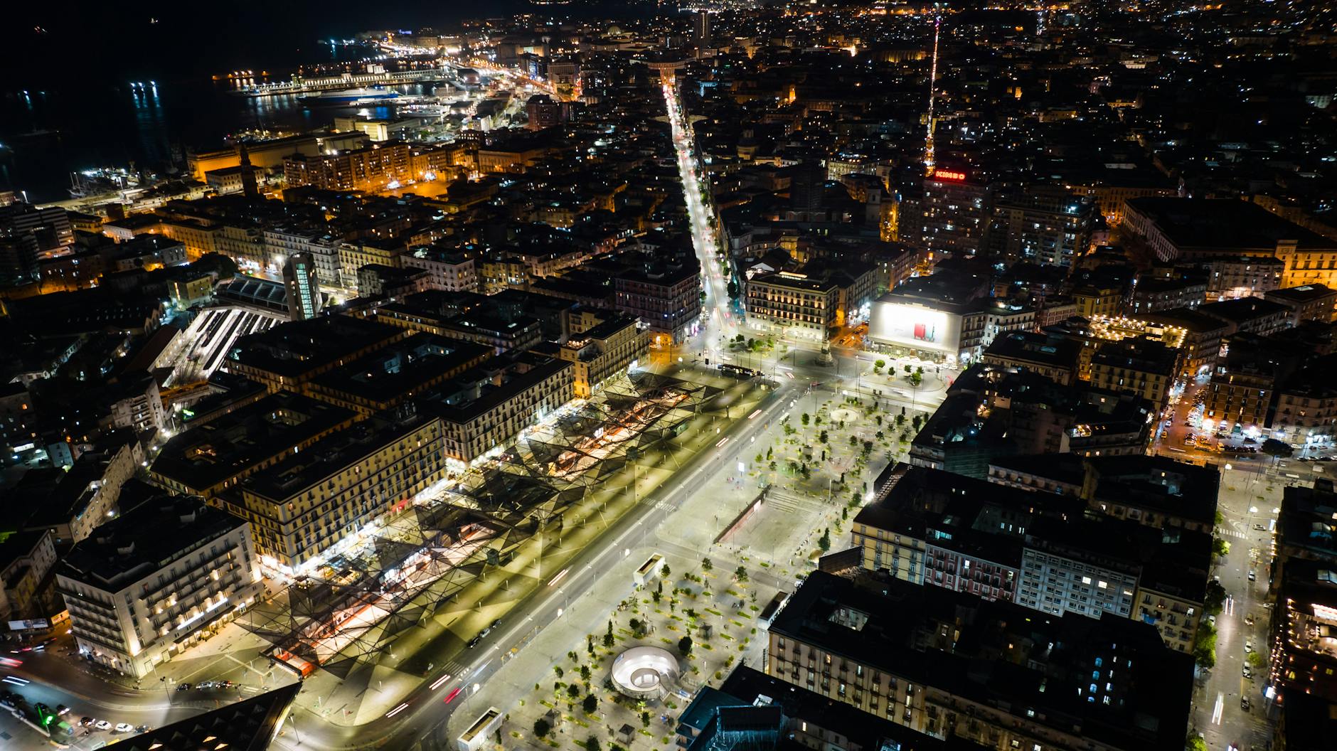 Aerial cityscape at night with illuminated streets