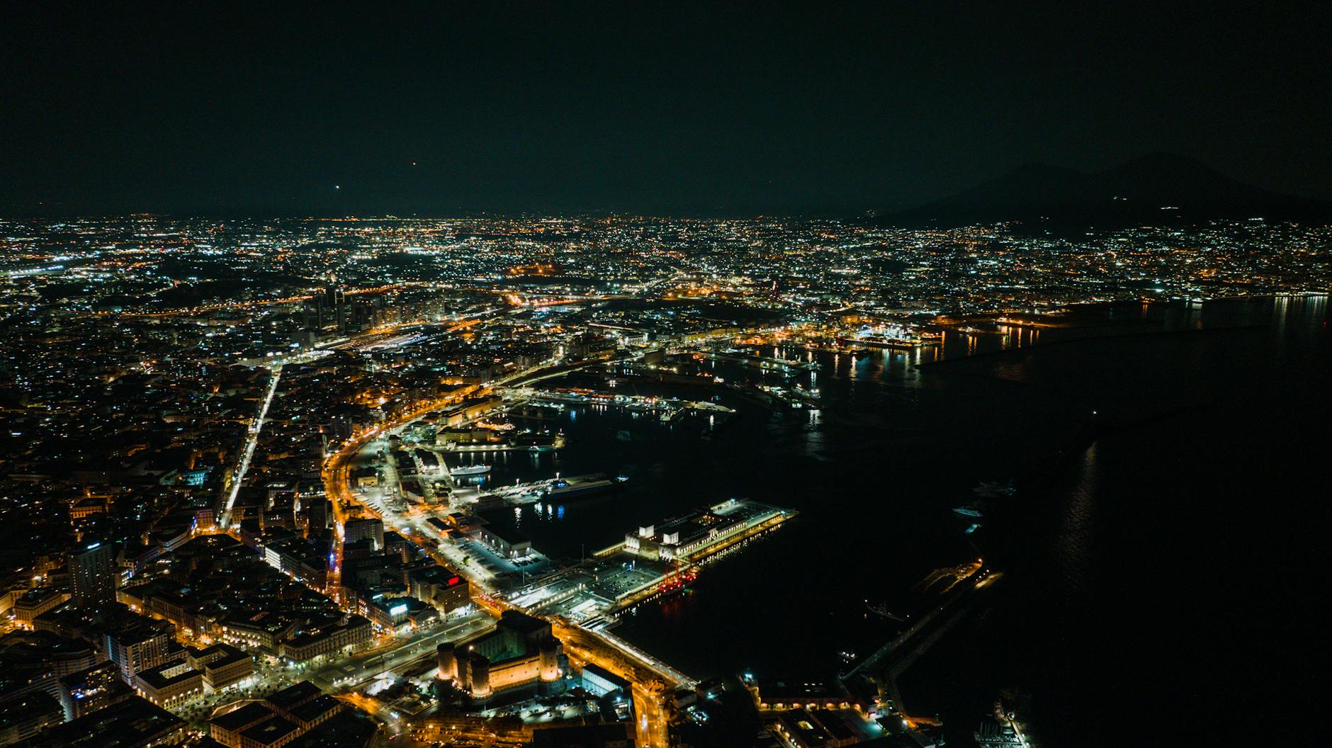 Aerial view of Naples city lights and coastline at night