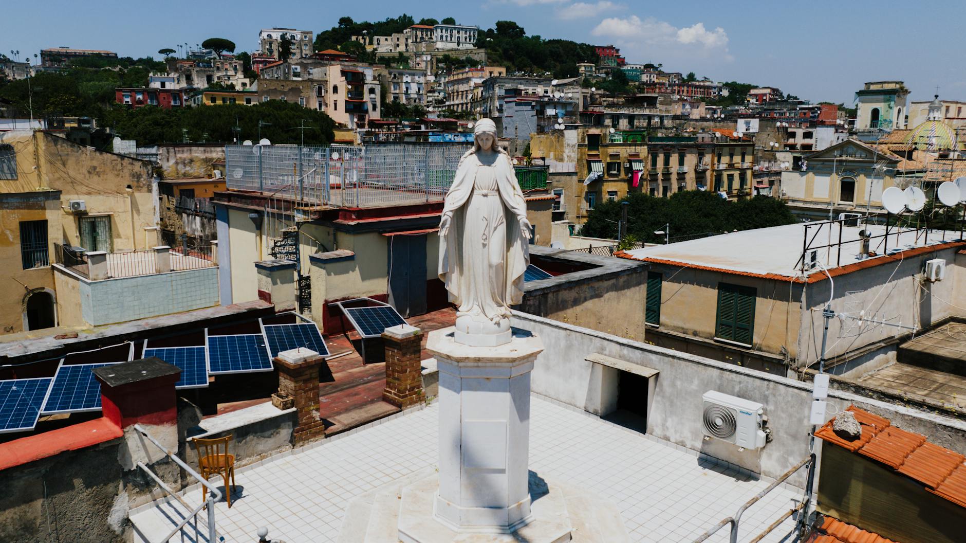 Rooftop statue among Naples architecture