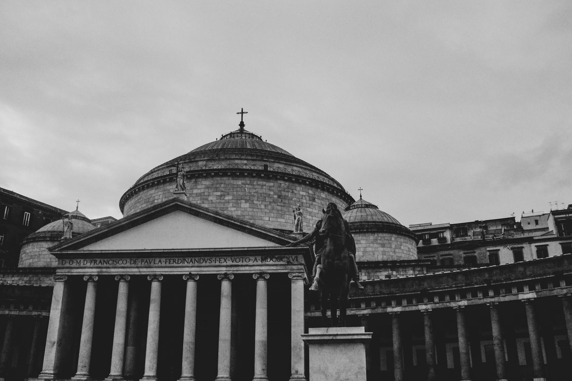Basilica facade with columns and statue in Naples