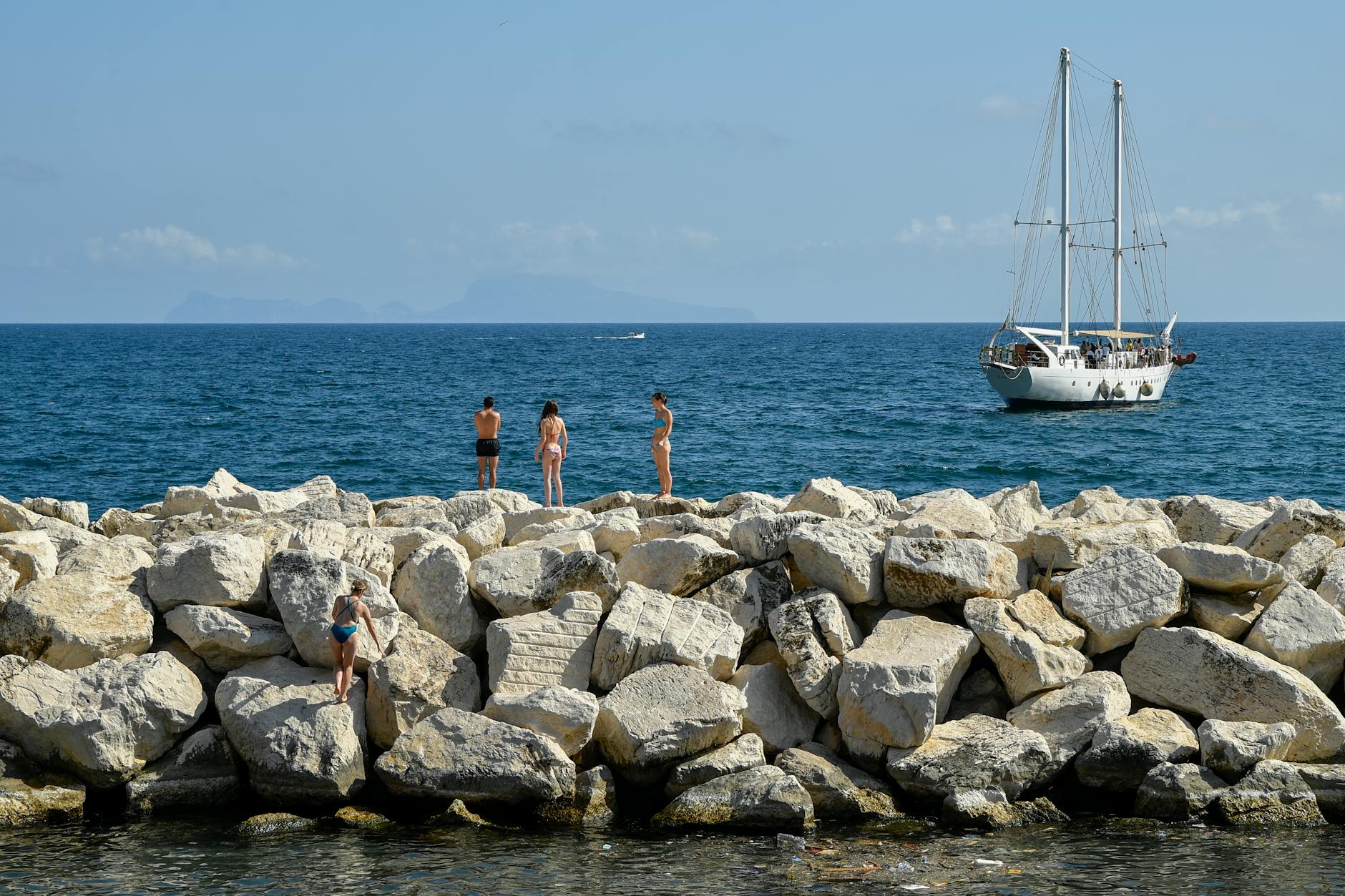 People enjoying the Naples waterfront by the sea
