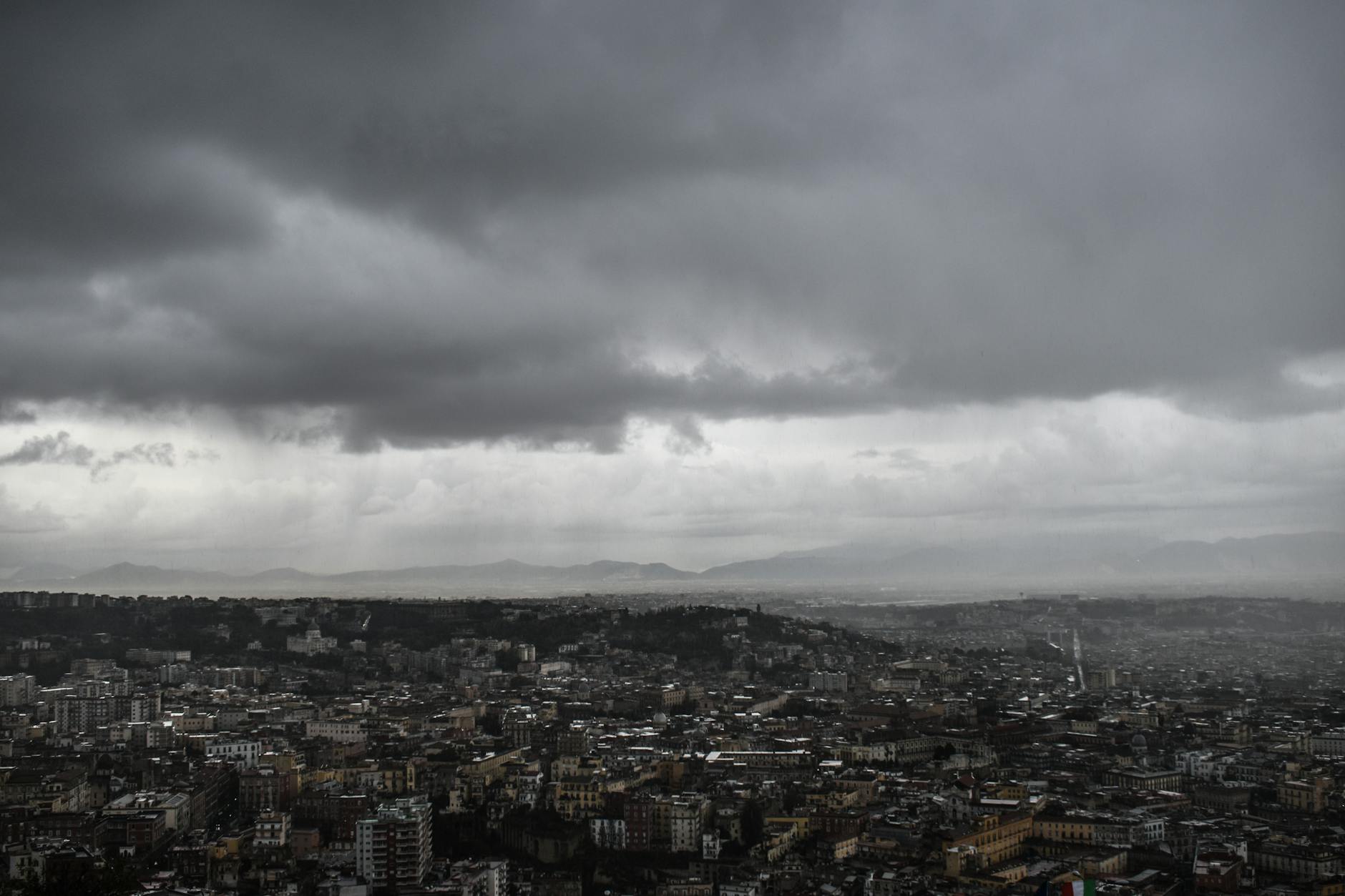Dense Naples cityscape under a dramatic sky