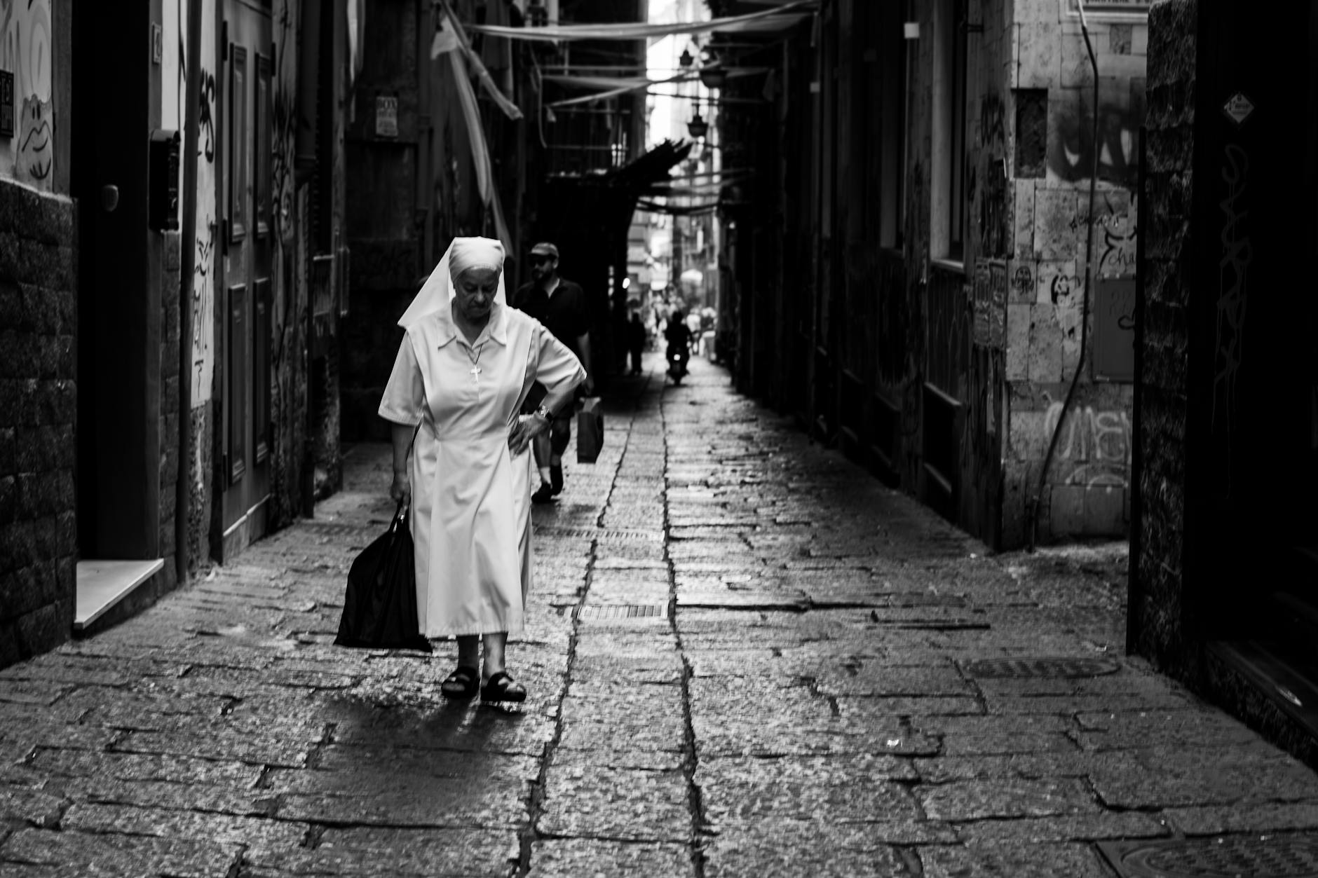 Narrow alley in Napoli with a lone pedestrian