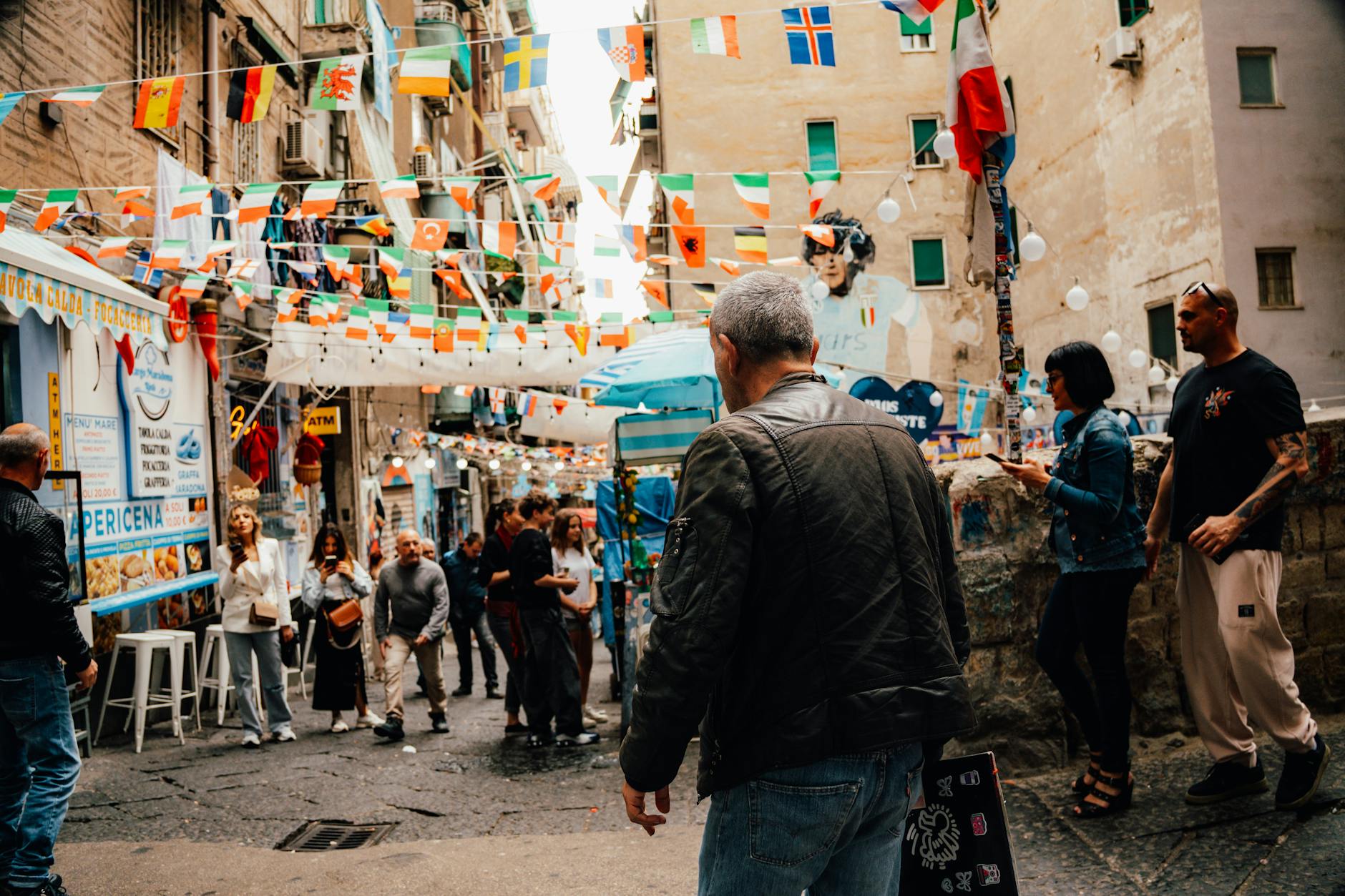 Busy street with flags and crowds