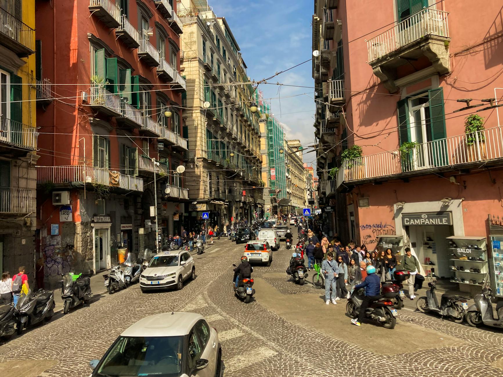 Busy Naples street with scooters and pedestrians