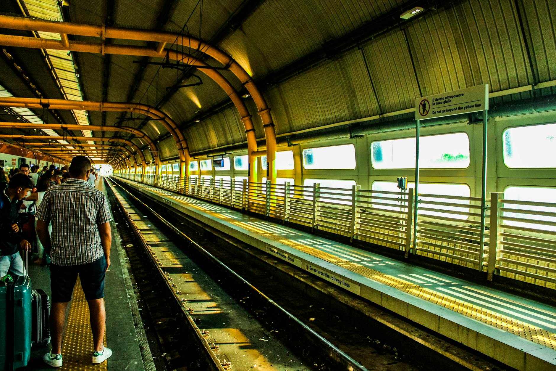 Commuters waiting at a busy train station platform