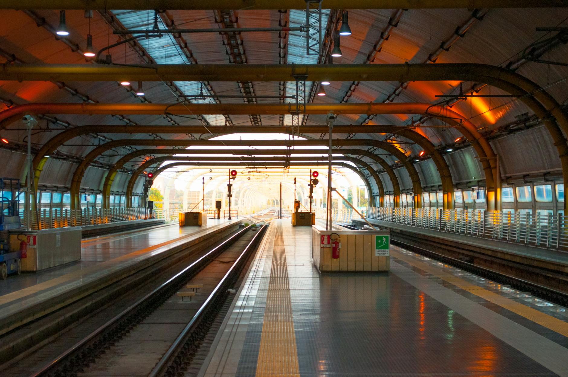 Modern railway station platform with tracks