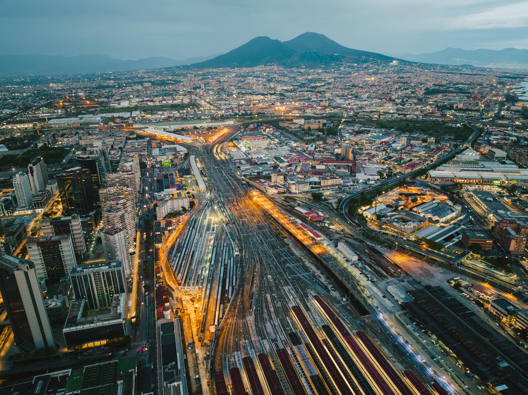 Naples cityscape at dusk with Mount Vesuvius behind the city