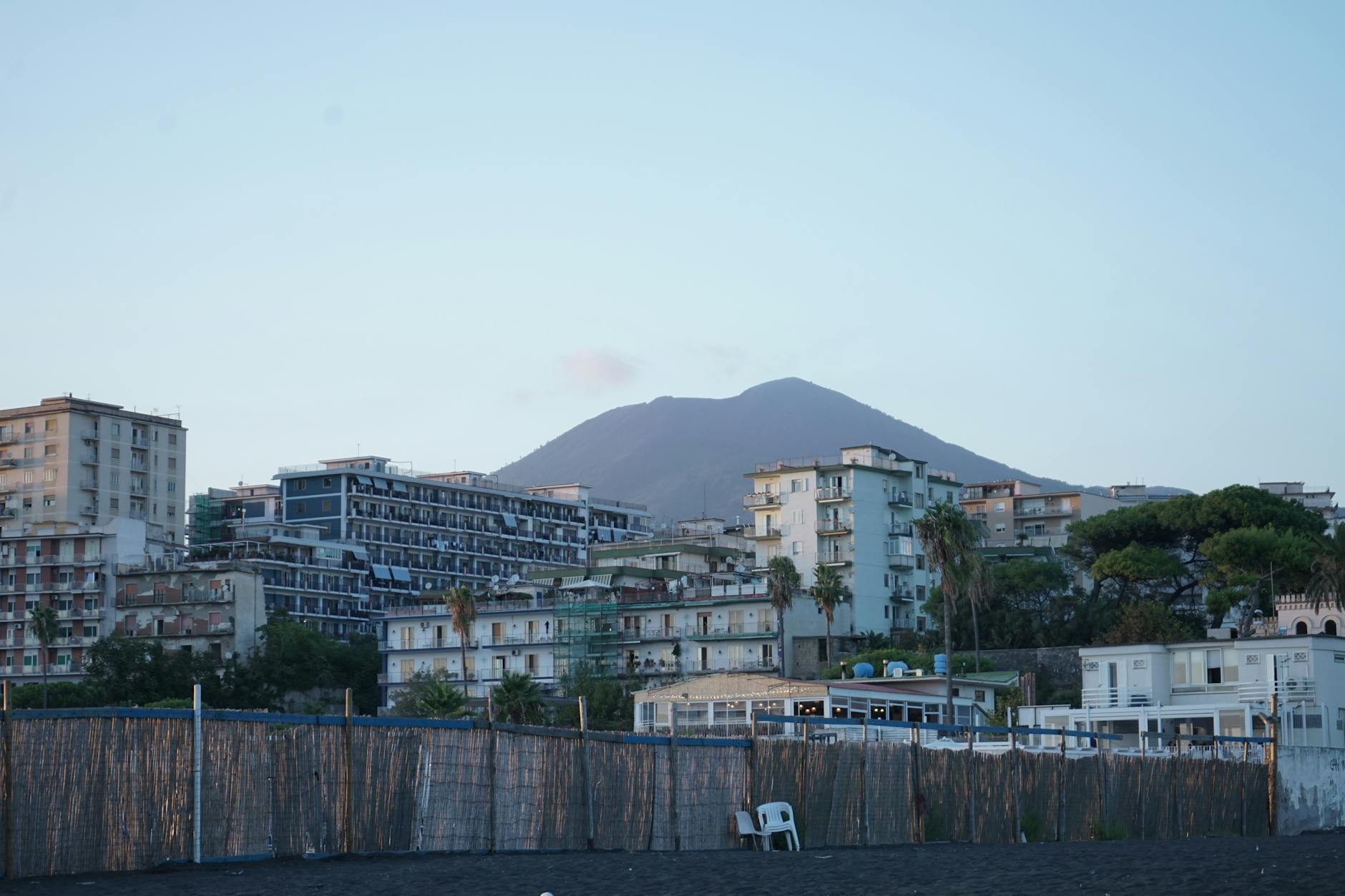 Coastal buildings in Naples with Mount Vesuvius in the distance