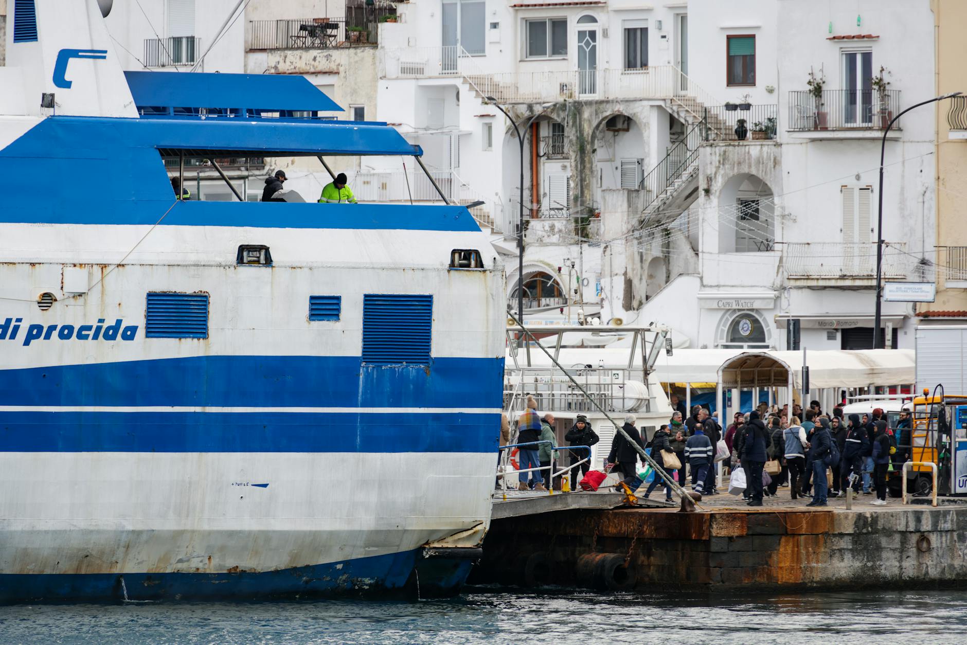 Passengers boarding a ferry at Procida harbor