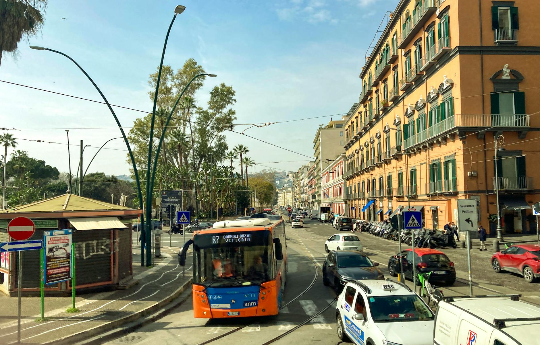 Busy Naples street scene with traffic and historic buildings