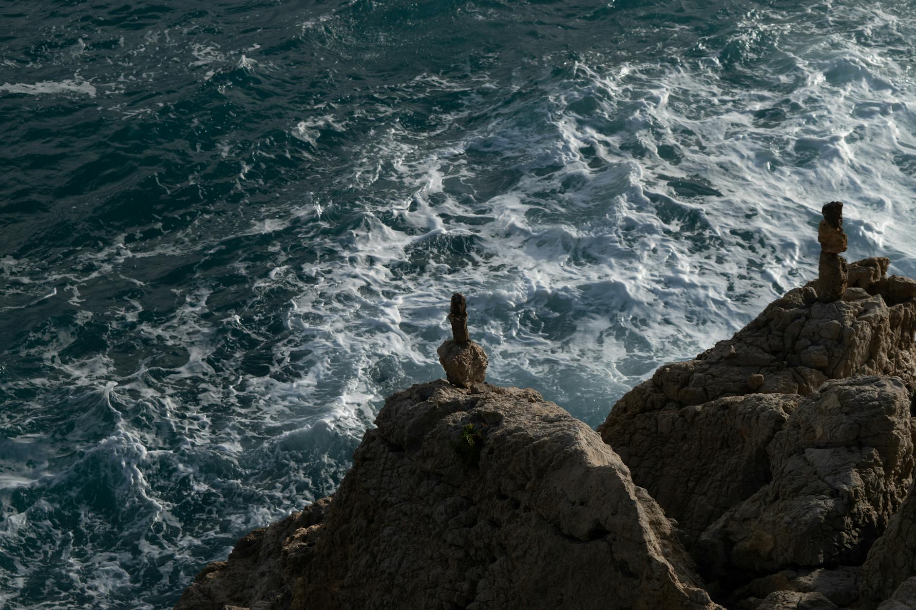 Rocky shoreline in Nice with azure waves from above