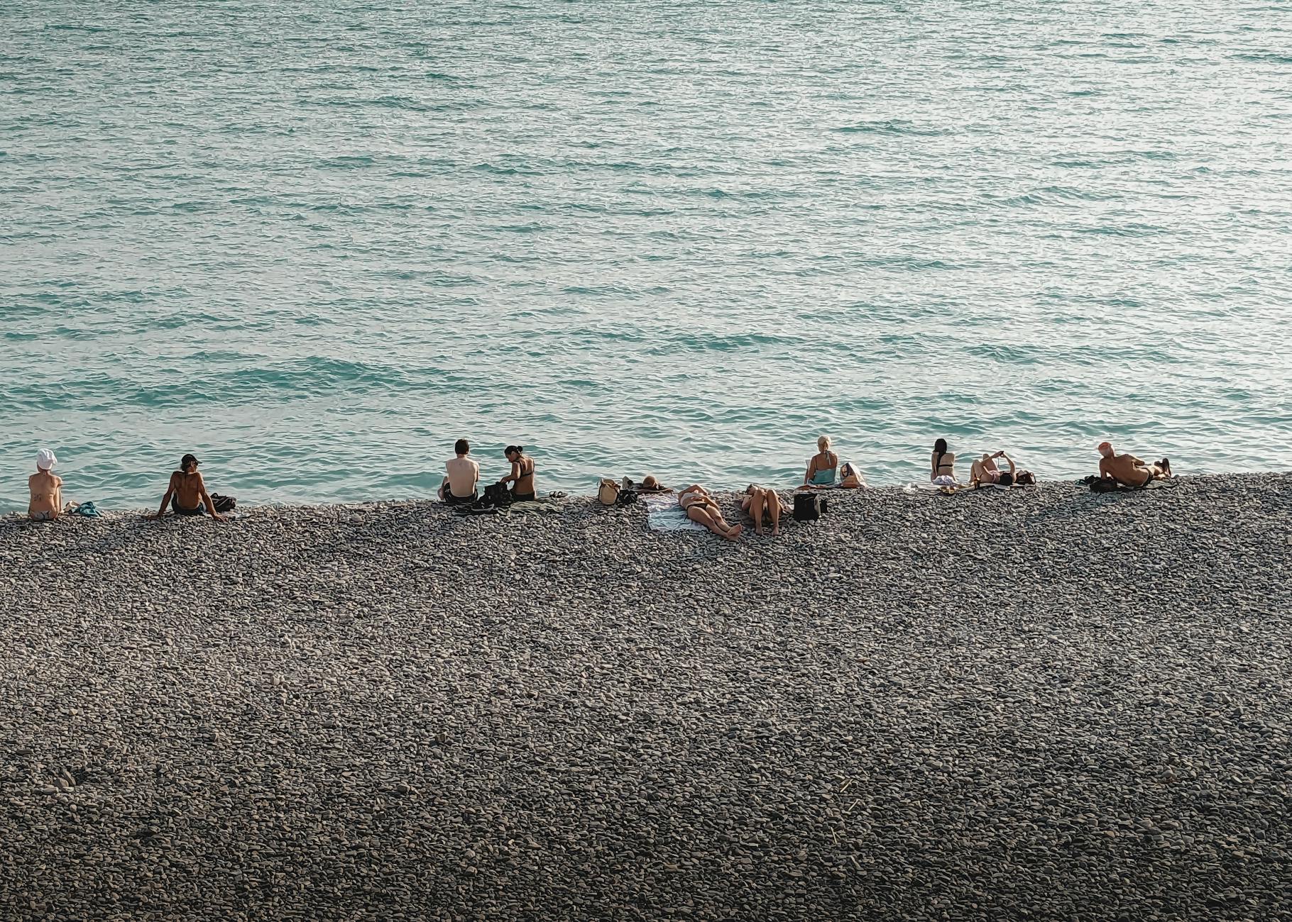 People sunbathing on the pebble beach in Nice