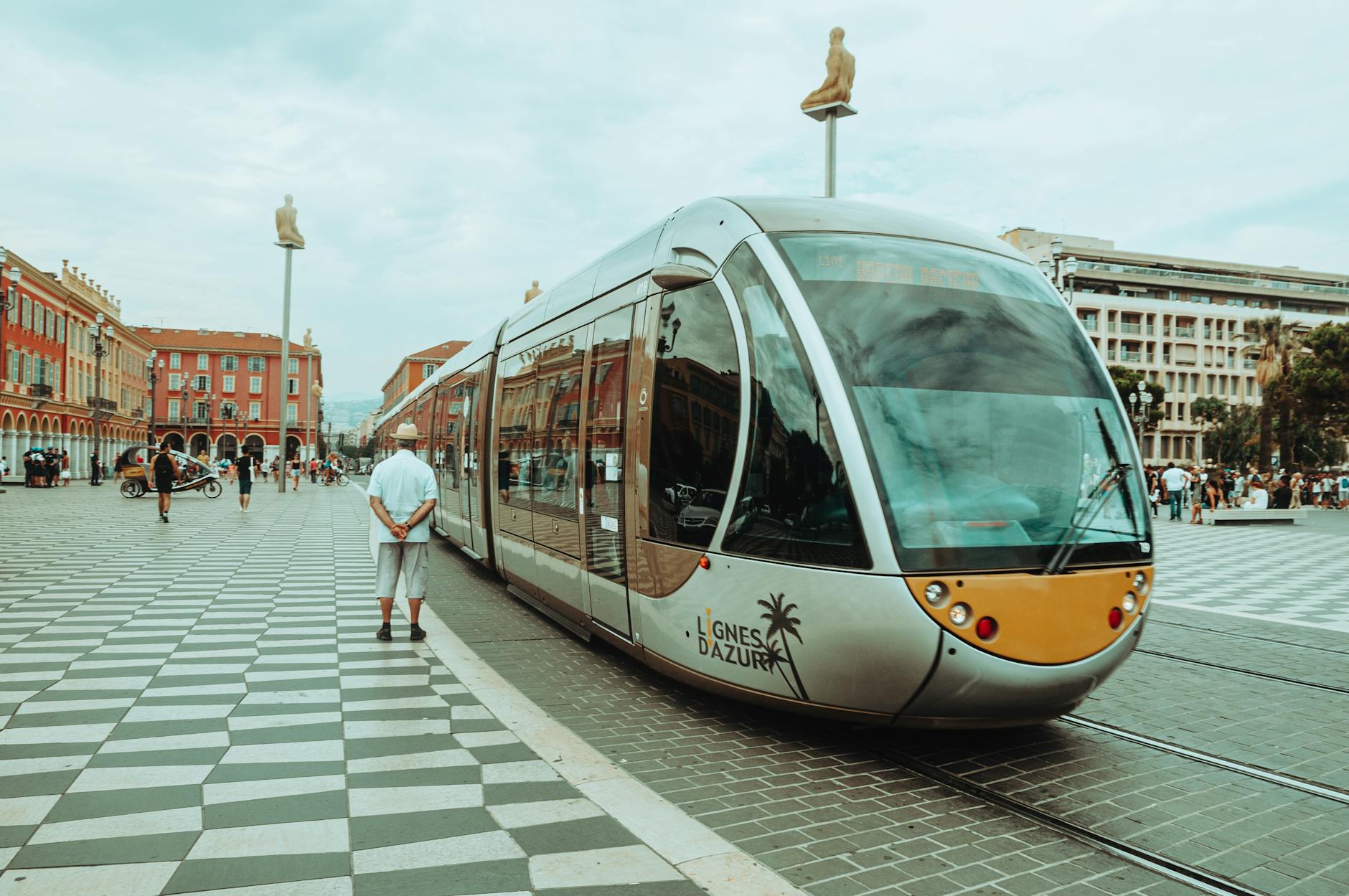 Modern tram traveling through a square in Nice