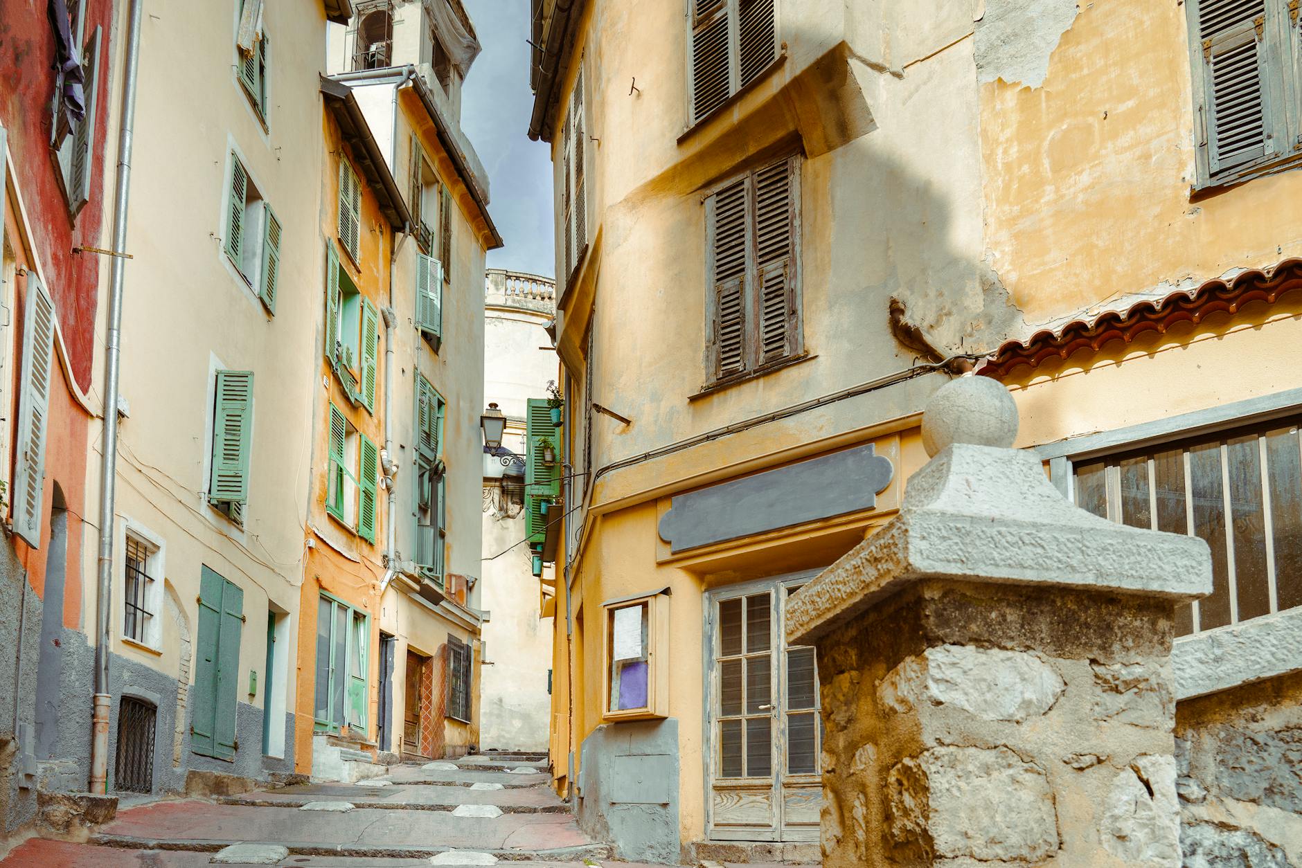 Narrow street in Nice old town with historic buildings