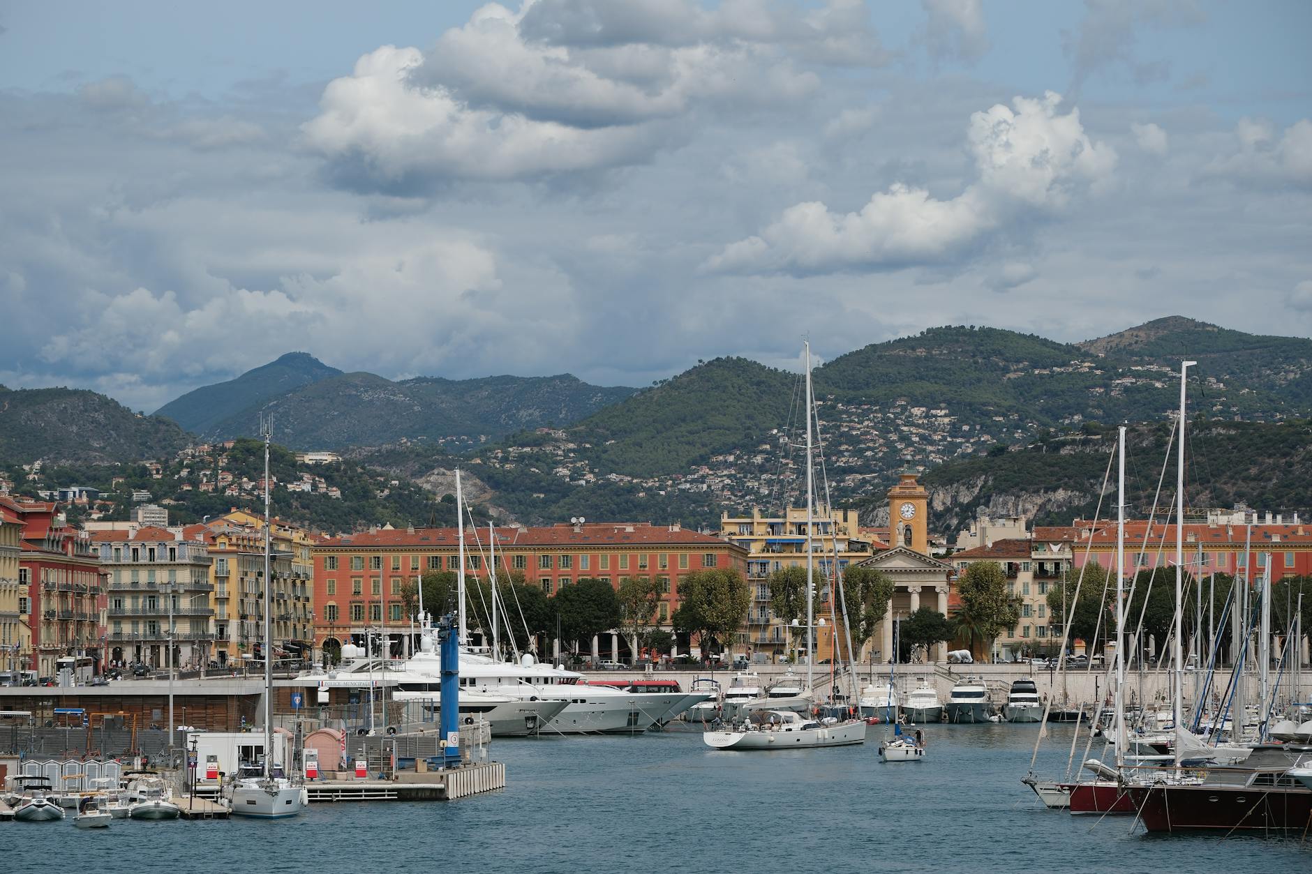 Port Lympia in Nice with yachts, mountains, and classic architecture
