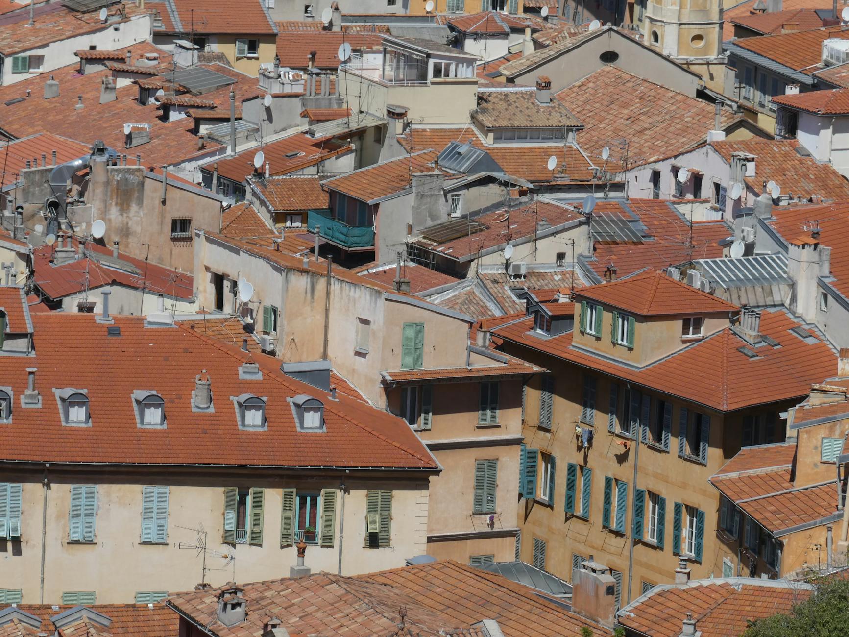 Sunlit terracotta rooftops in Nice from above