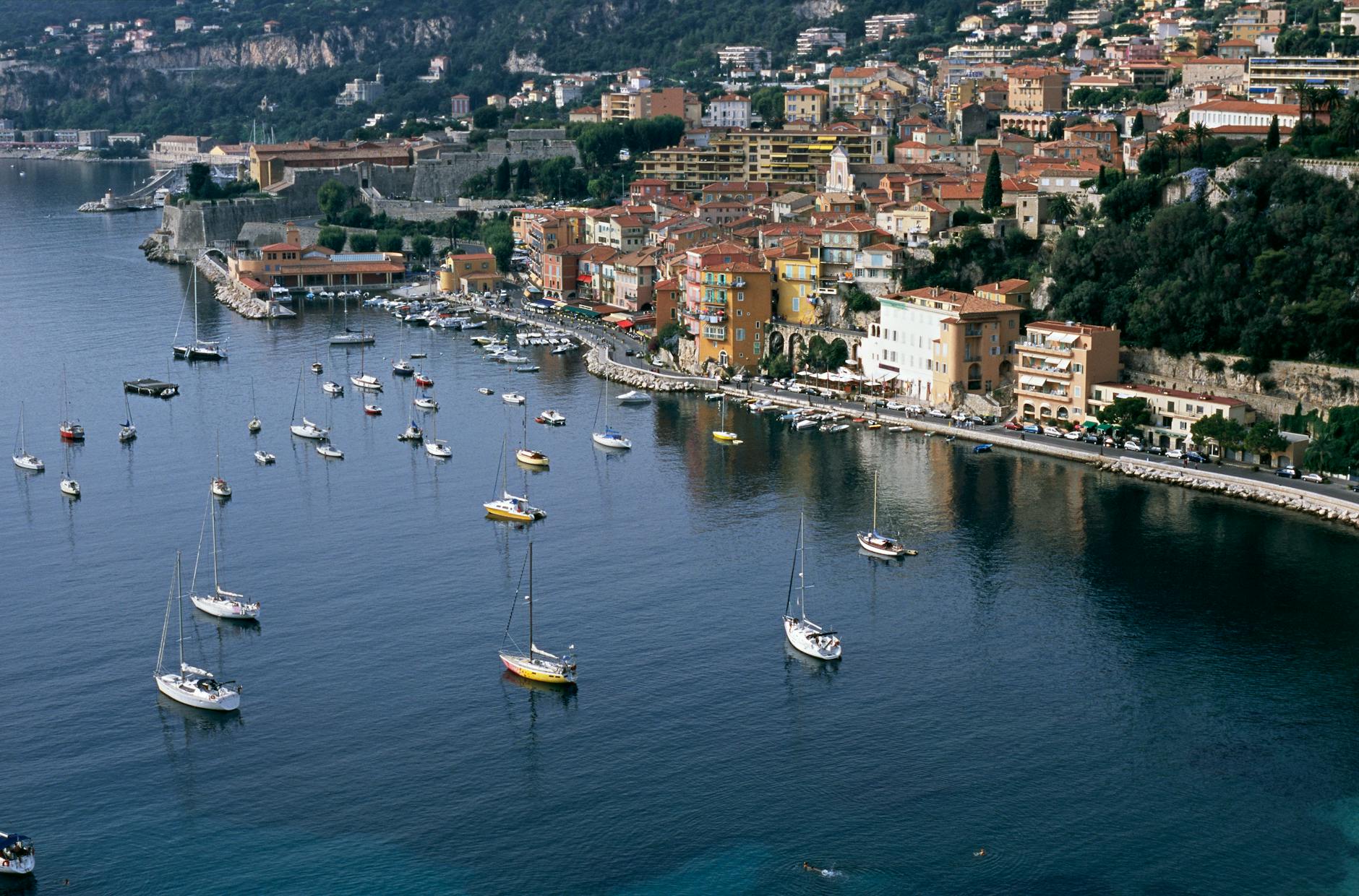 Villefranche-sur-Mer harbor with sailboats and coastal buildings
