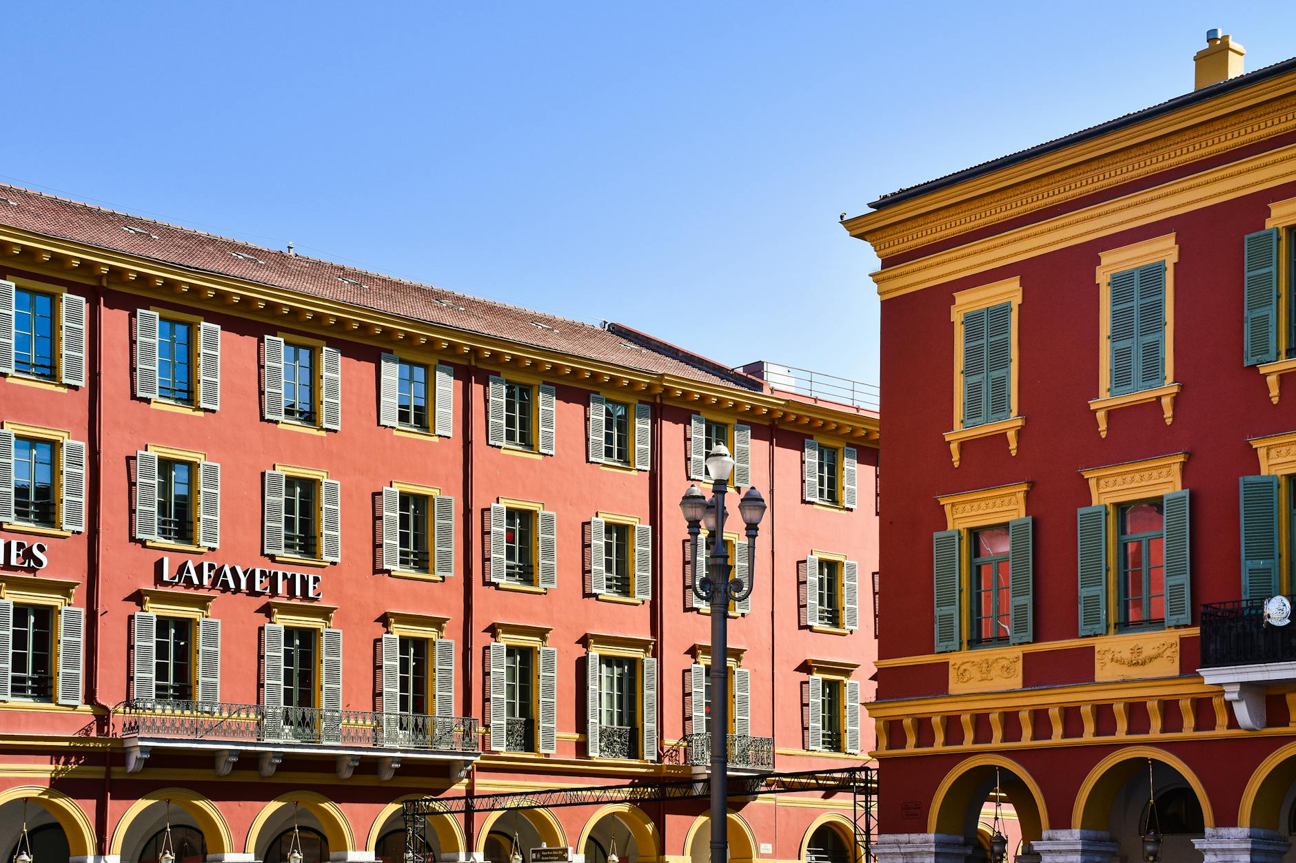 Red buildings with shutters in Nice city center