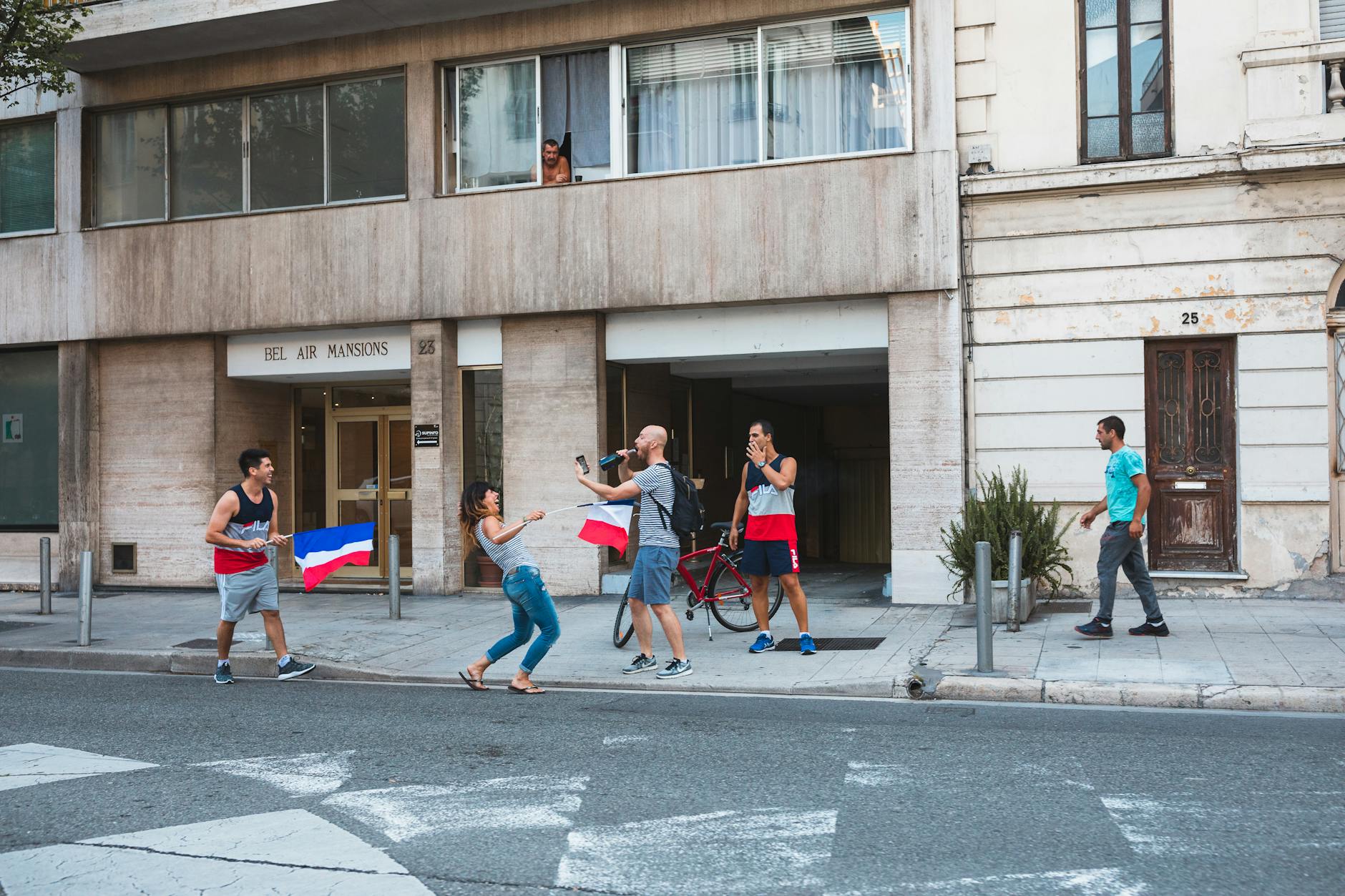 People on a Nice street with French flags