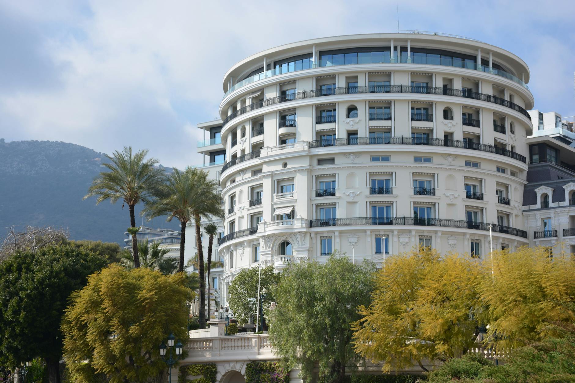 Round luxury hotel building with palm trees