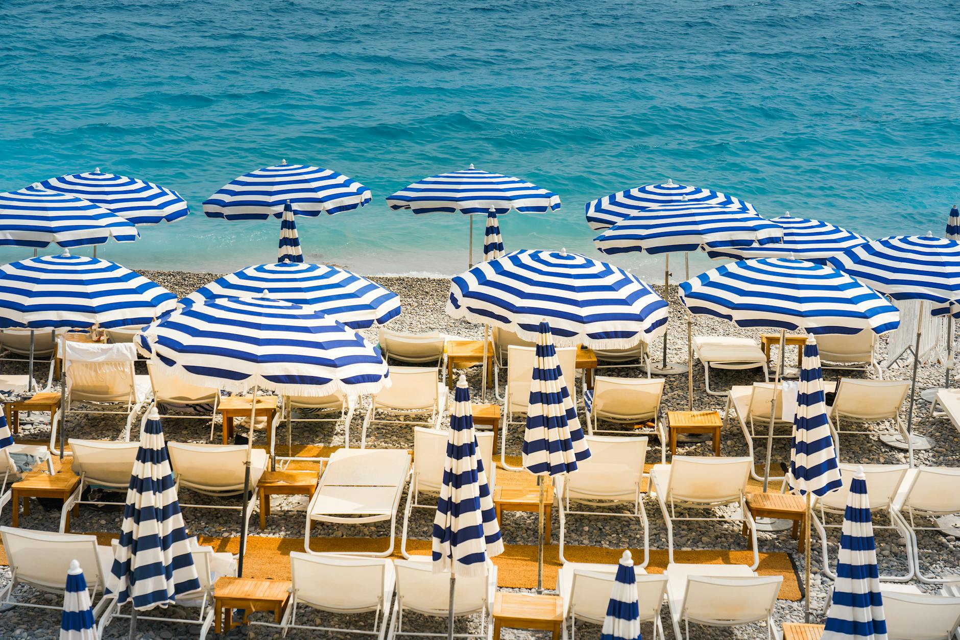 Beach umbrellas and lounge chairs on the Nice coast