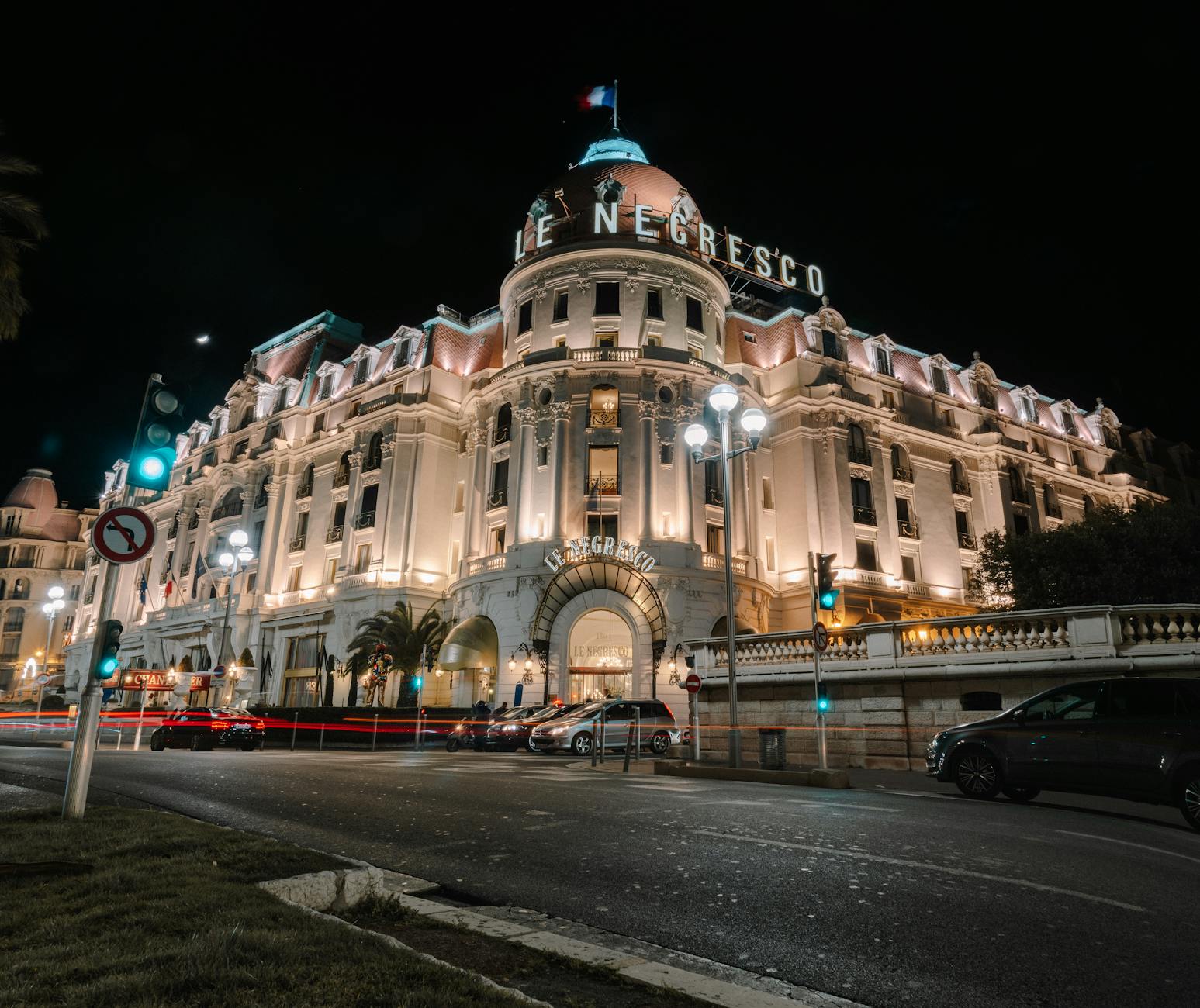 Illuminated neoclassical hotel on the Promenade in Nice