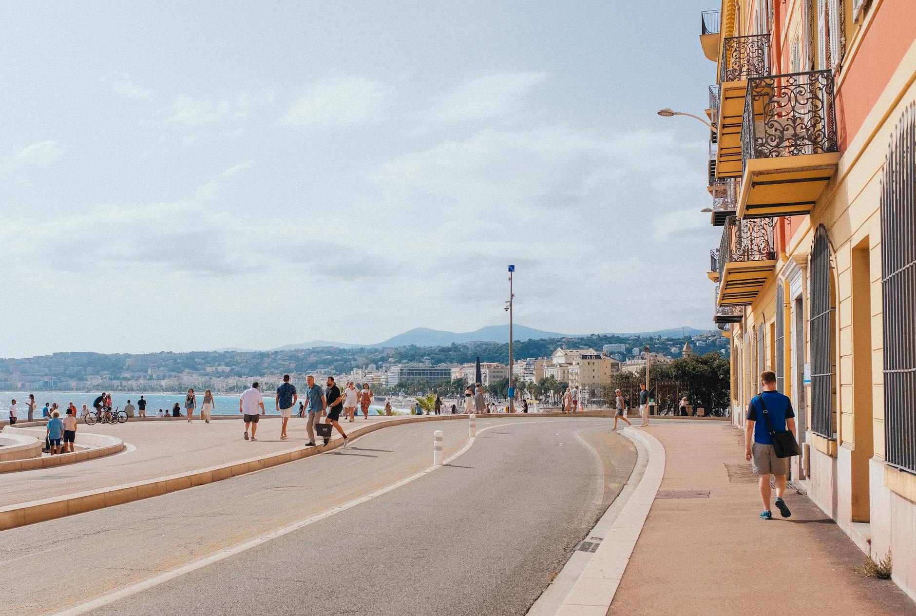 Sunny coastal promenade with walkers and cyclists