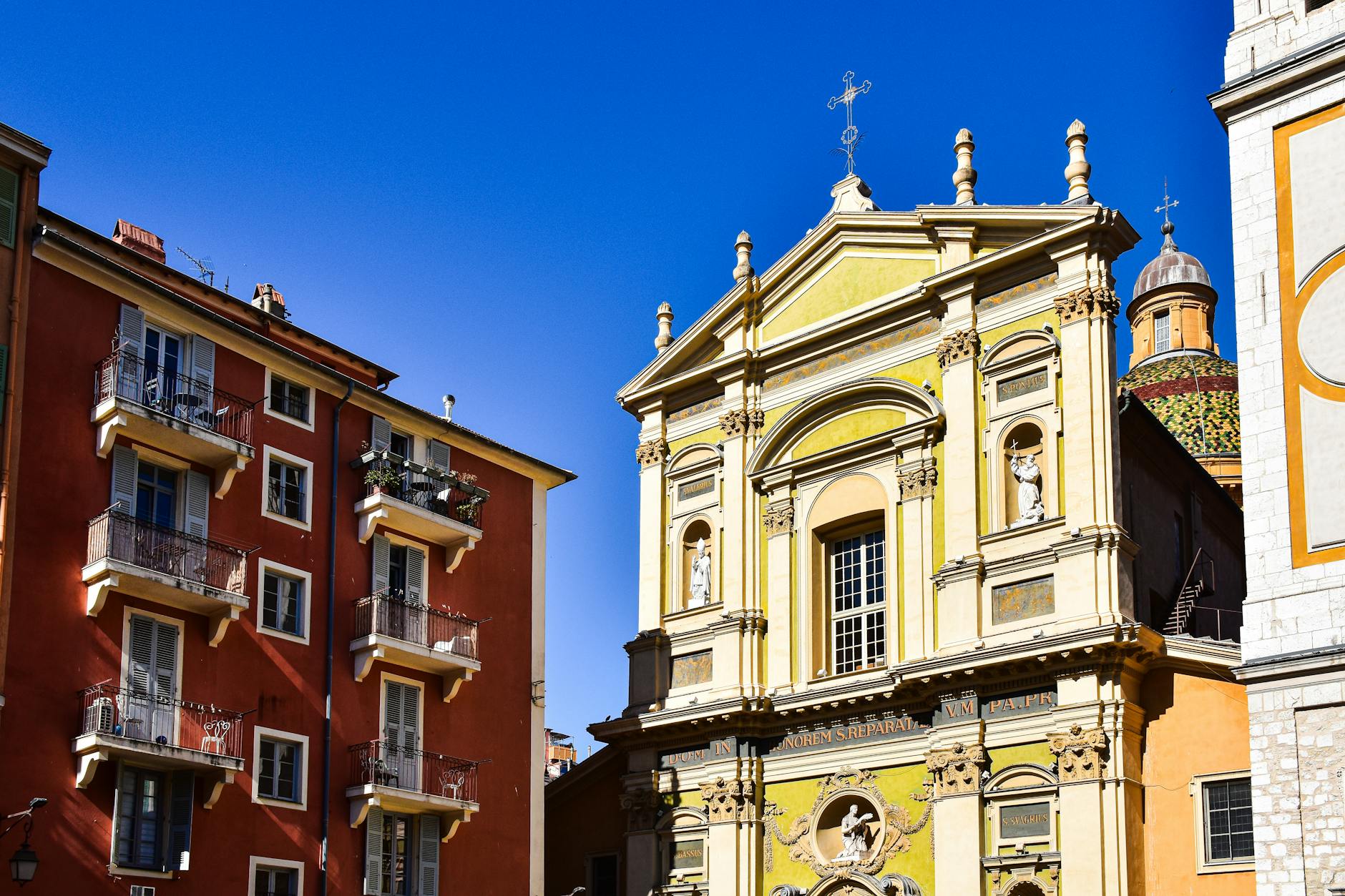 Vibrant historic facade in Nice under a blue sky