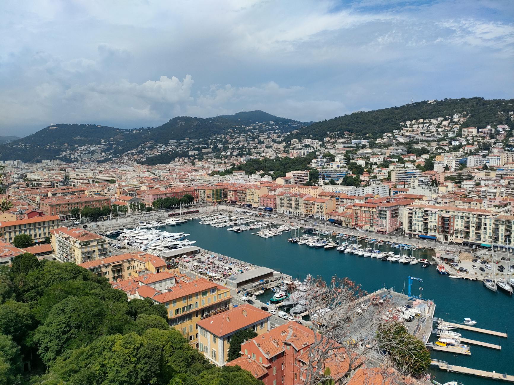 Aerial view of Nice harbor with colorful buildings and mountains