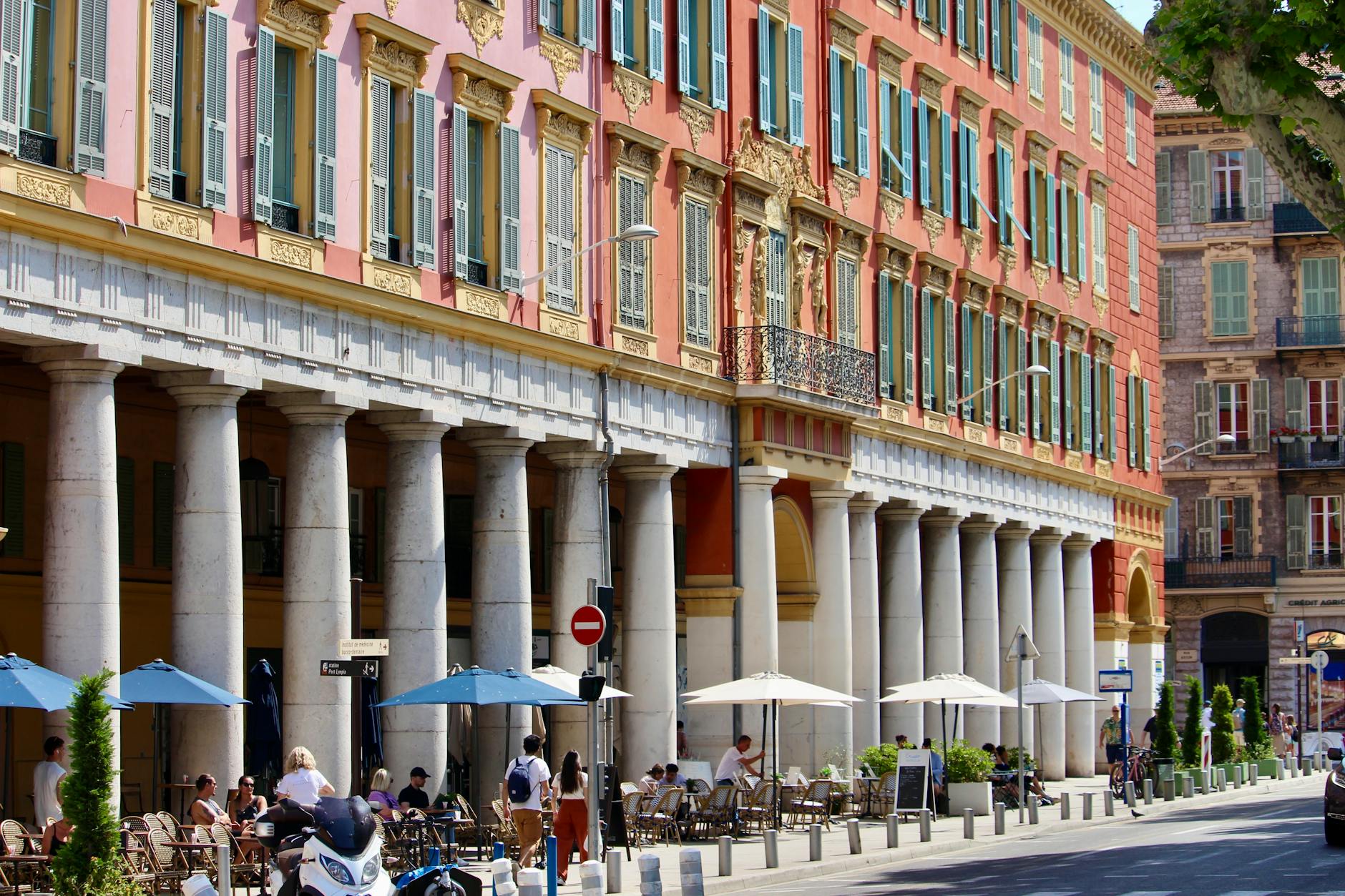 Nice street with outdoor cafes and neoclassical buildings