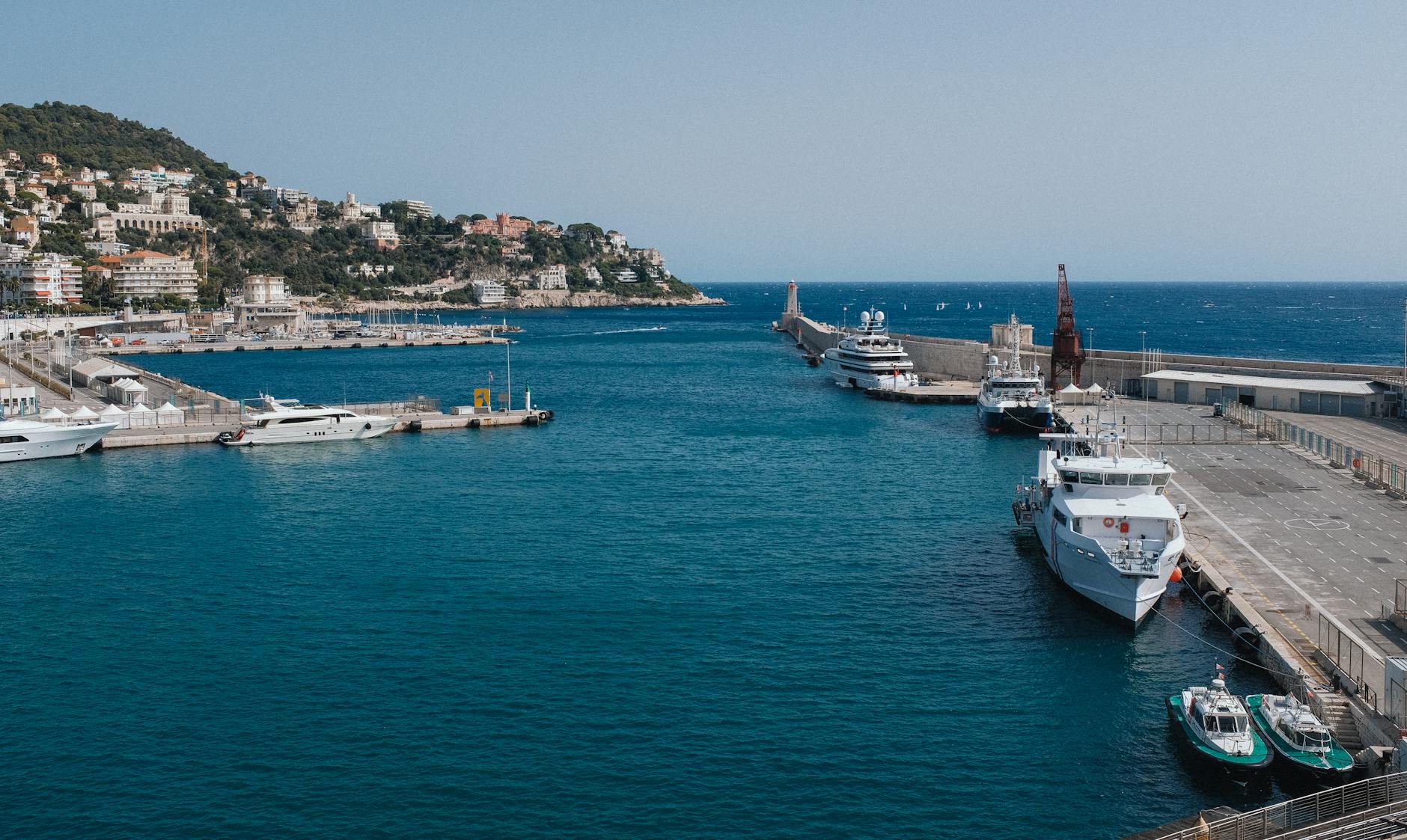Port with yachts docked along the Riviera coastline