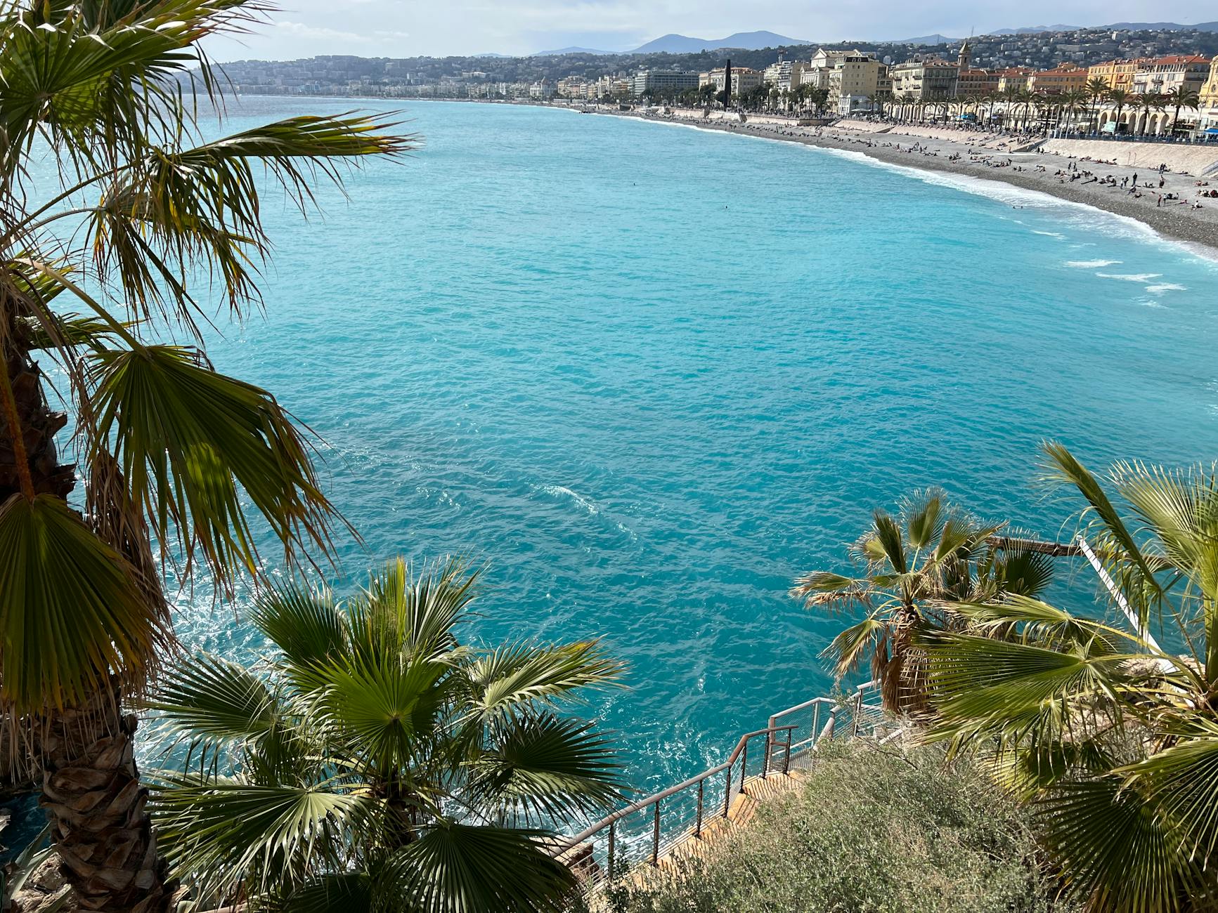 Aerial view of Nice coastline with palm trees and turquoise sea