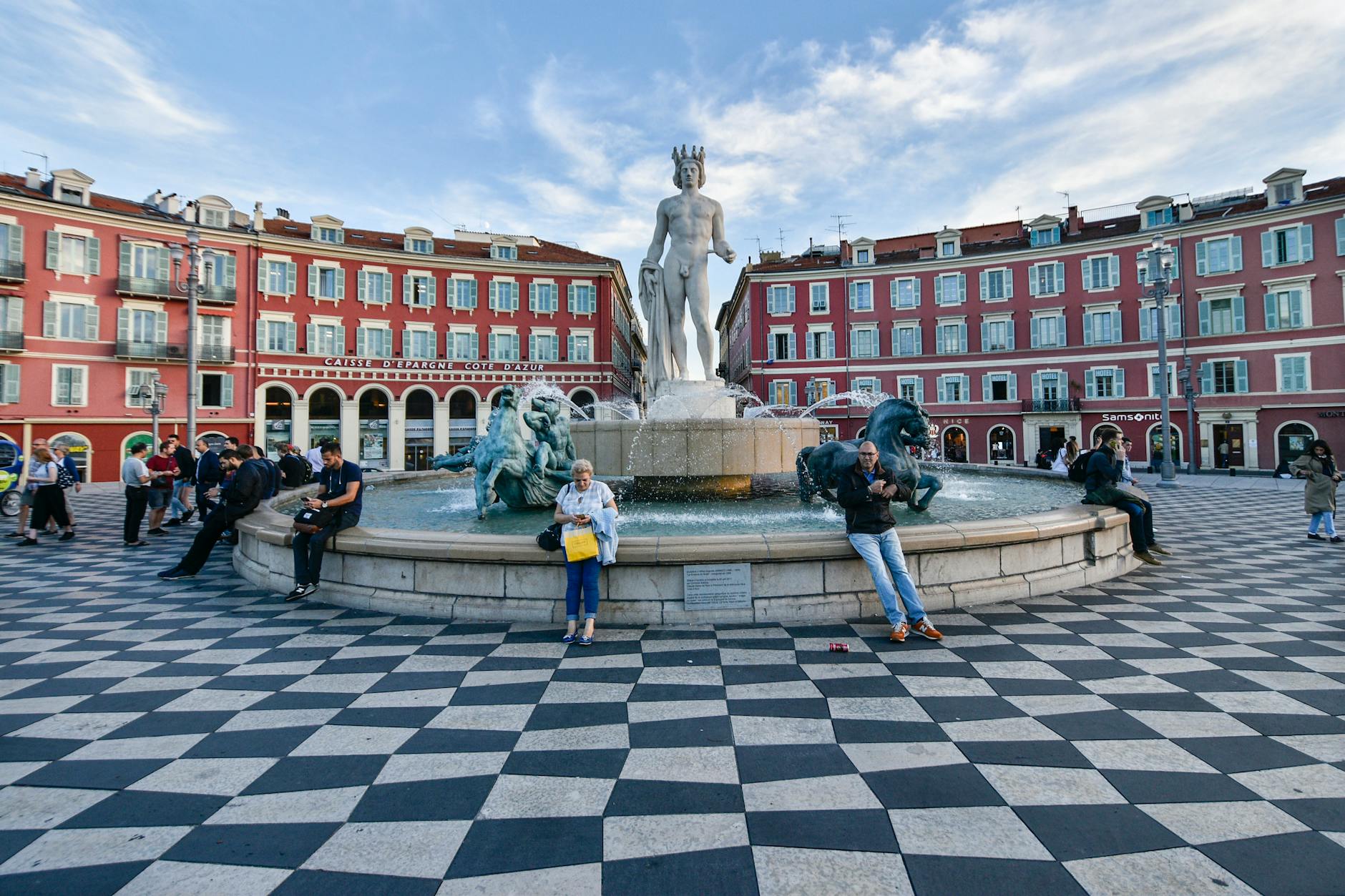 People at Place Massena fountain in Nice on a sunny day