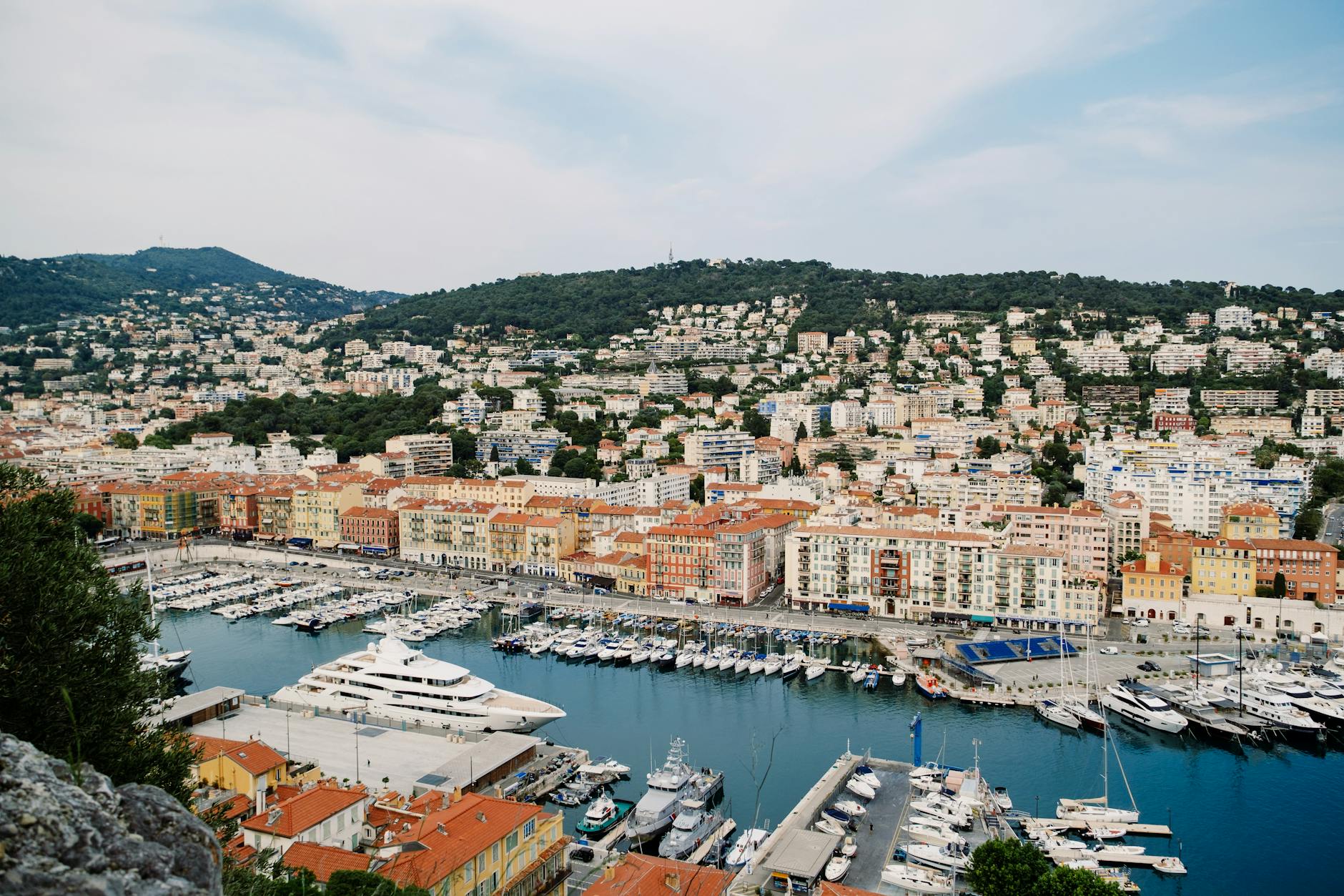 Aerial view of Nice harbor with yachts and hillside cityscape