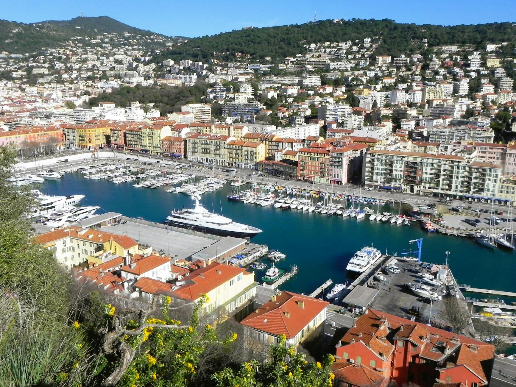 Bird's-eye view of Port Lympia in Nice with boats and colorful buildings