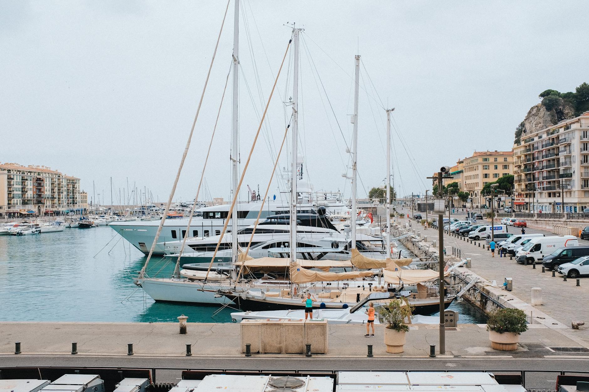 Marina in Nice with yachts, waterfront buildings, and coastal scenery