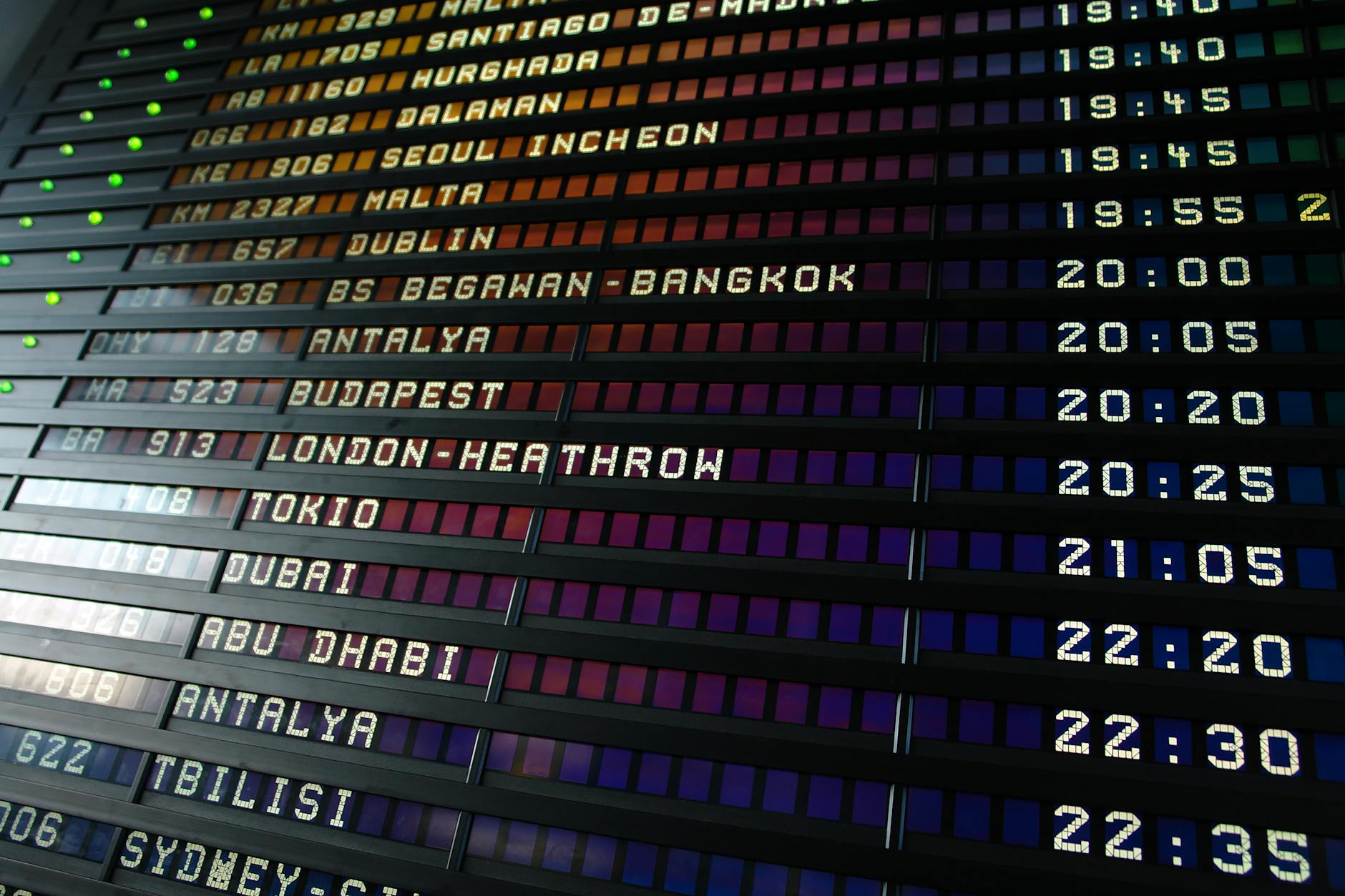 Airport departure board showing flight destinations and times