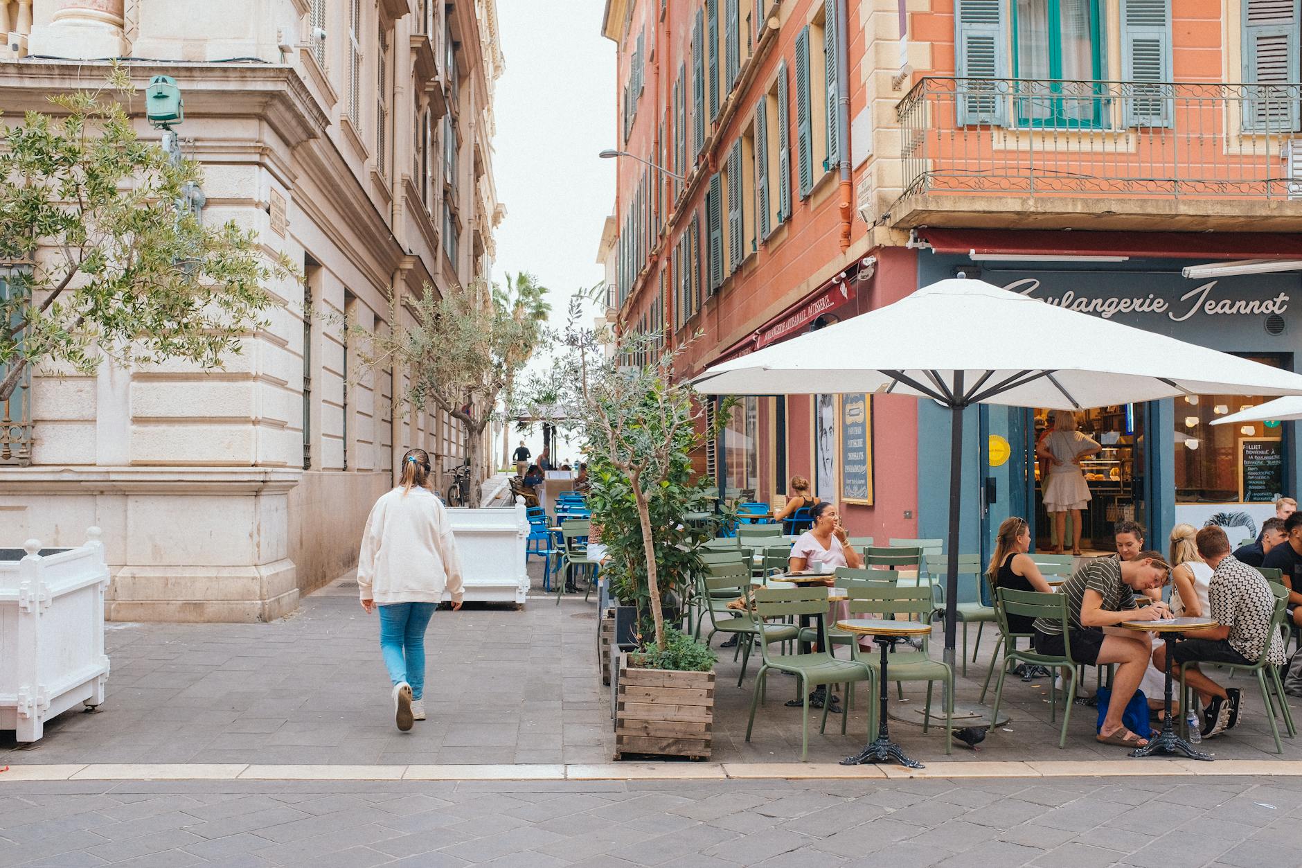 Outdoor cafe seating on a sunny street in Nice
