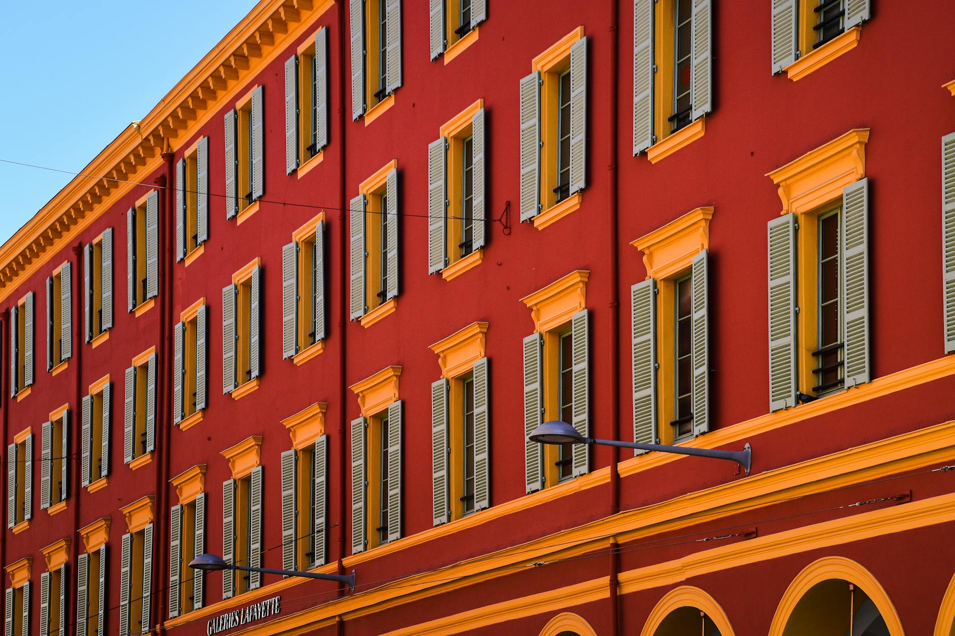 Historic building facade in Nice with red and yellow colors
