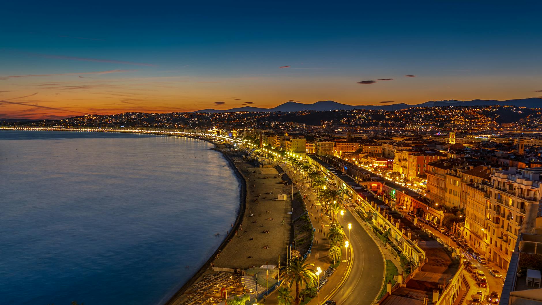Twilight view of Nice city lights and Mediterranean coastline