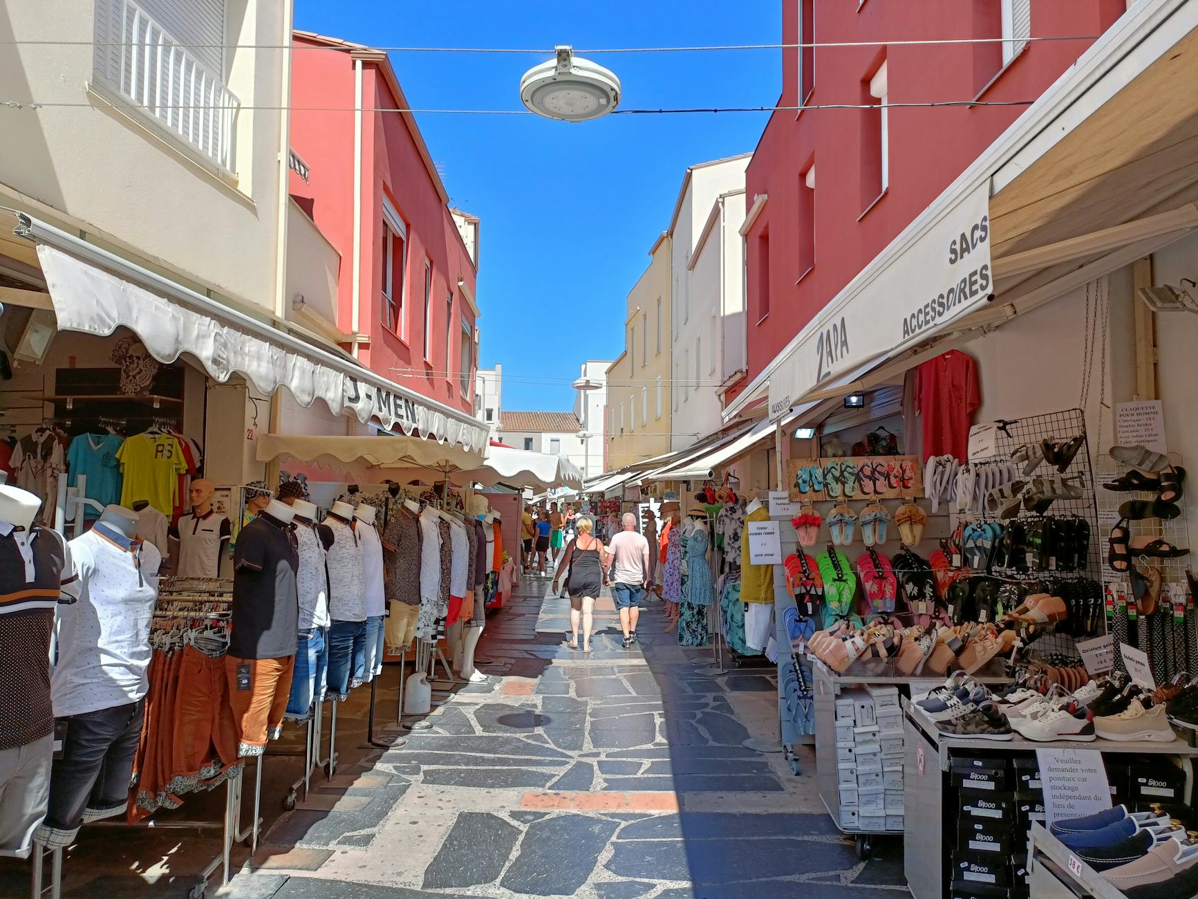 Outdoor summer market street with shops and people walking