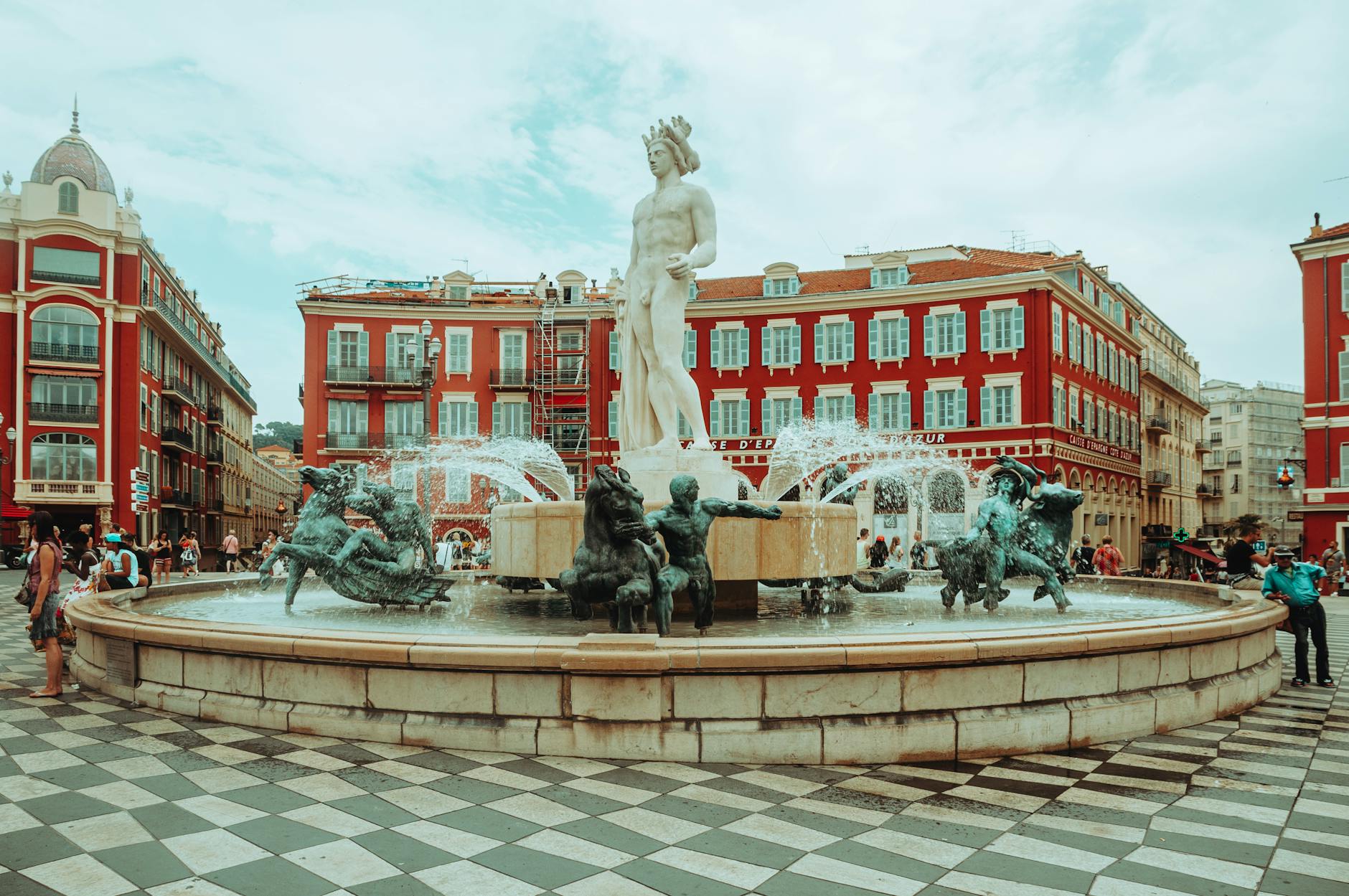 People walking near the Fountain of the Sun in Nice