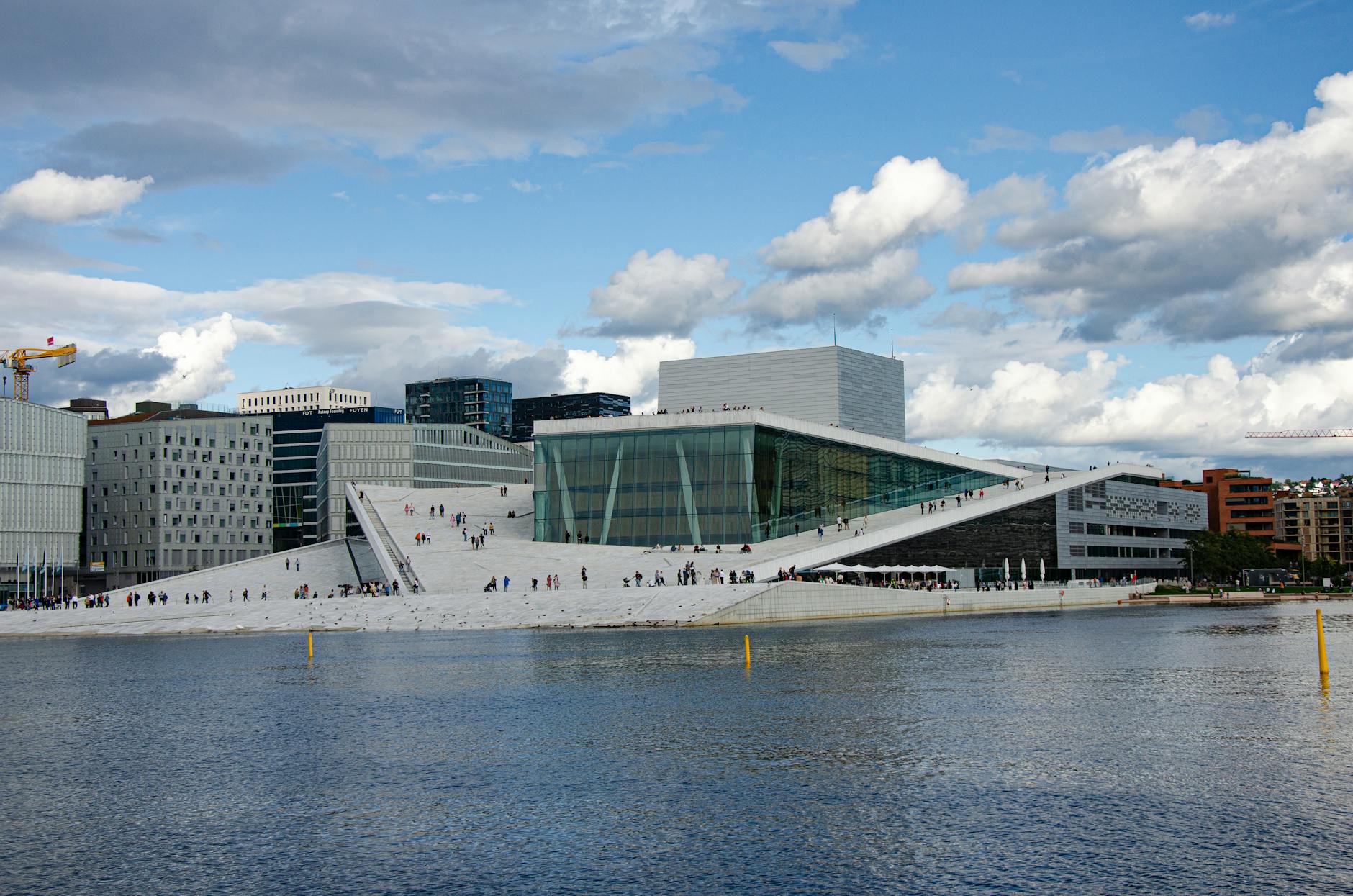 Oslo Opera House by the waterfront under a blue sky