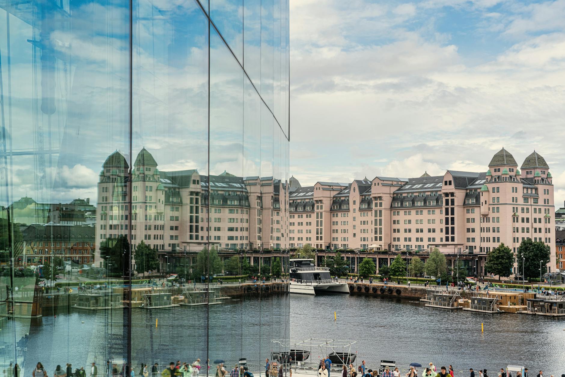 Modern glass building reflecting Oslo waterfront architecture