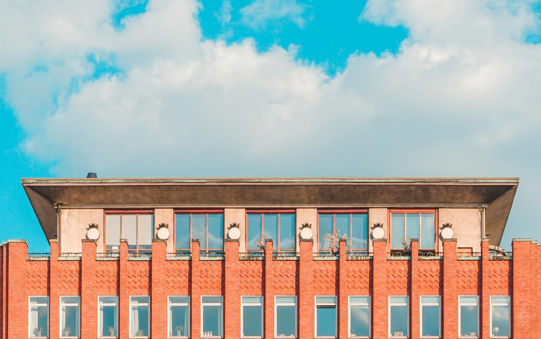 Modern red brick building in Oslo under blue sky